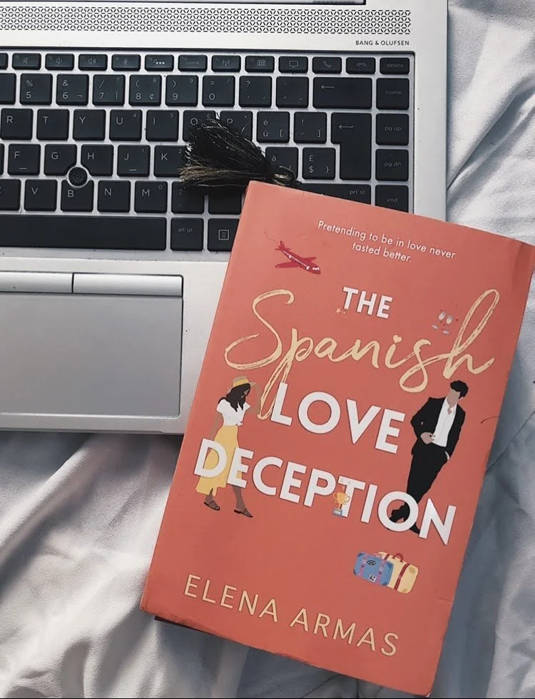 Photo of book cover sitting on top of a laptop keyboard.