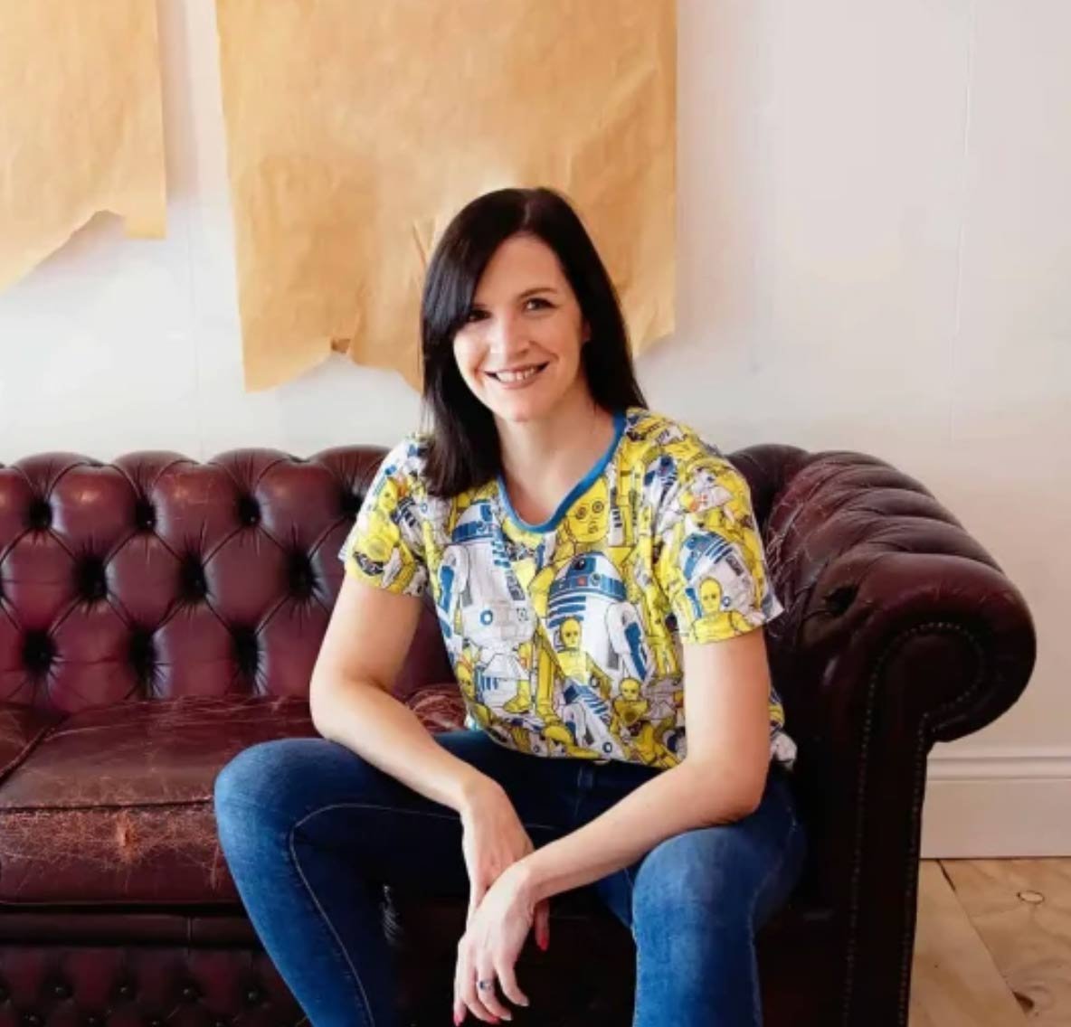 Photo of Katie from Aether Digital posing on a couch