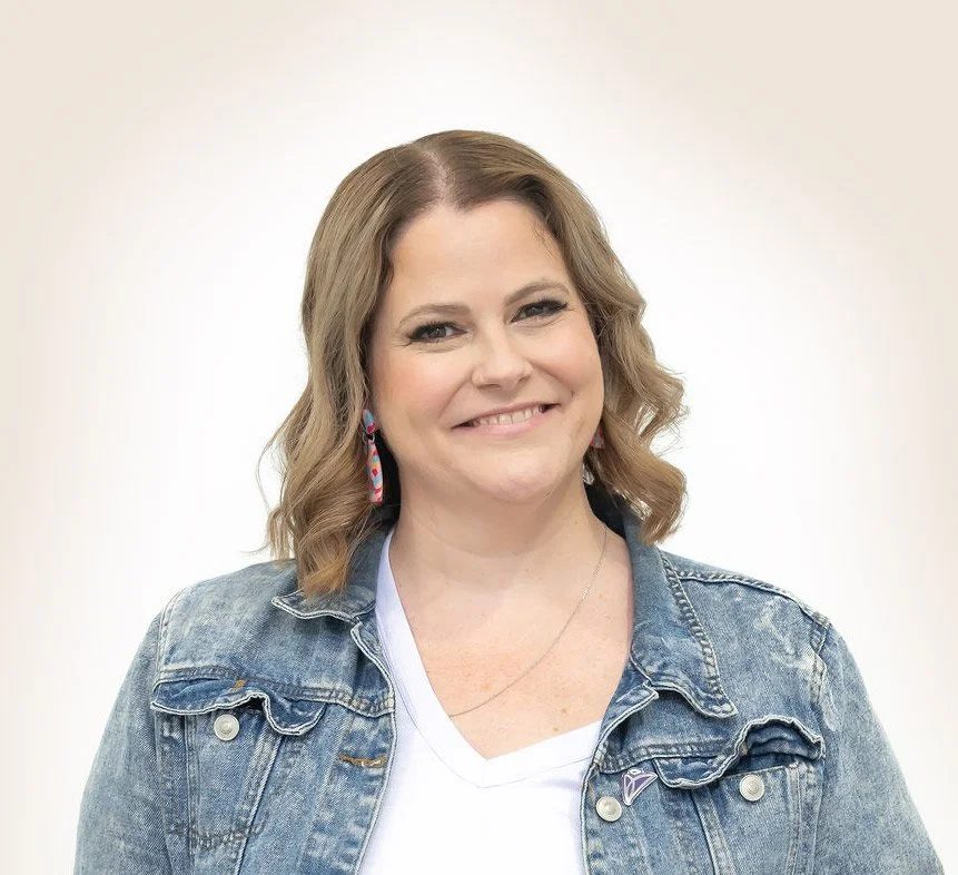 Janelle web designer smiling in denim jacket