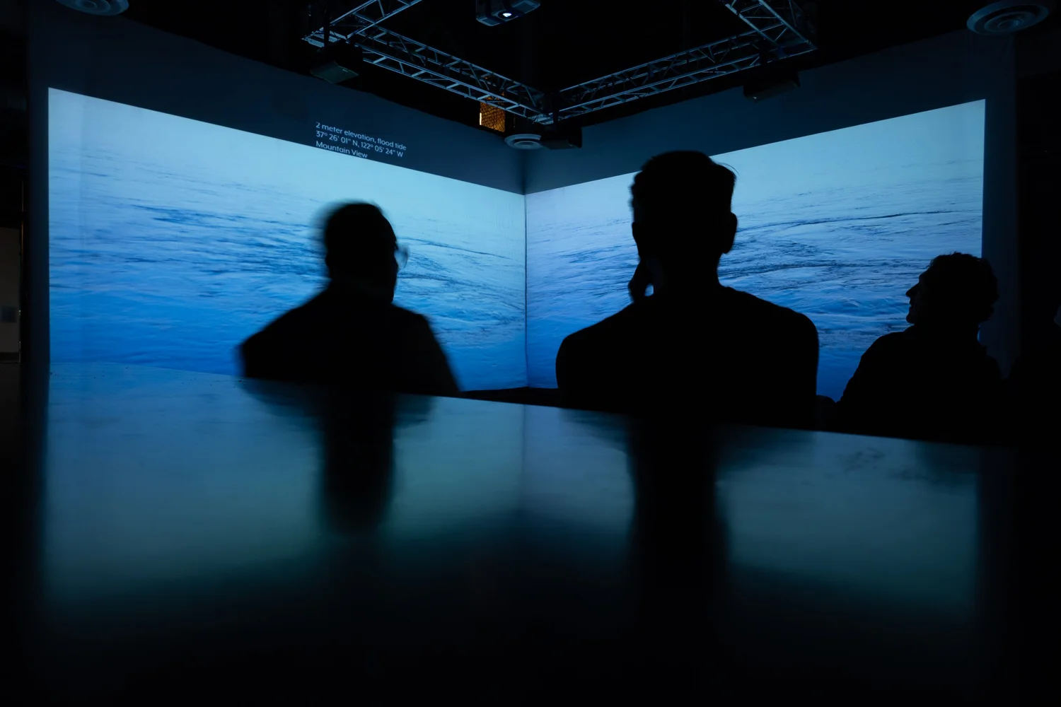 Audience silhouettes in front of a projection