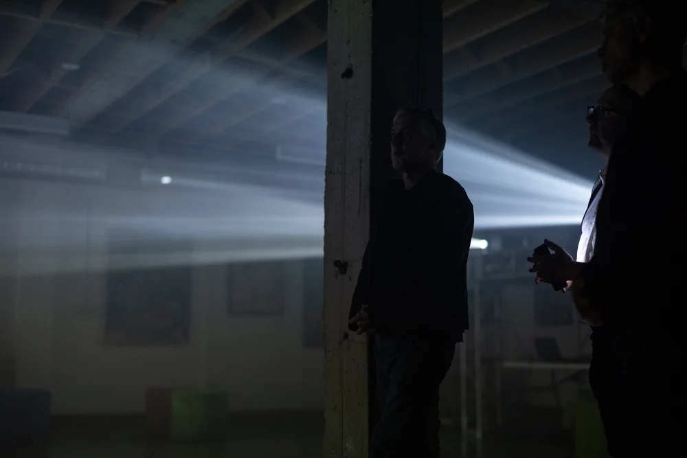 Figures in beams of light at an arts festival