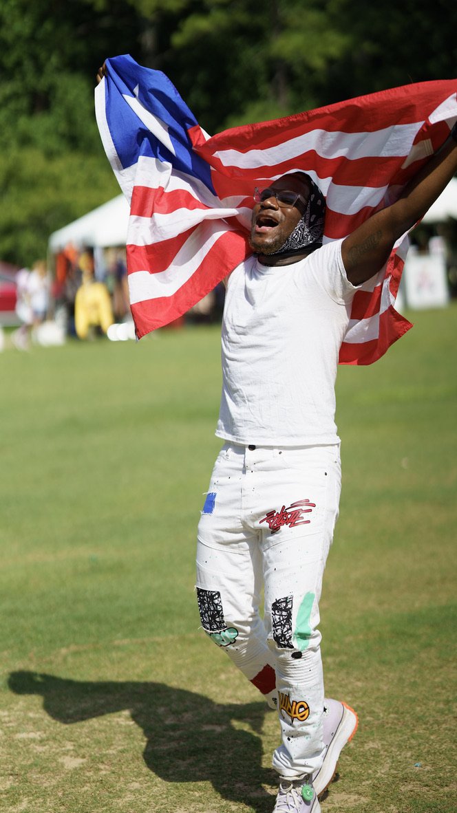 Man celebrating with a large Liberian flag