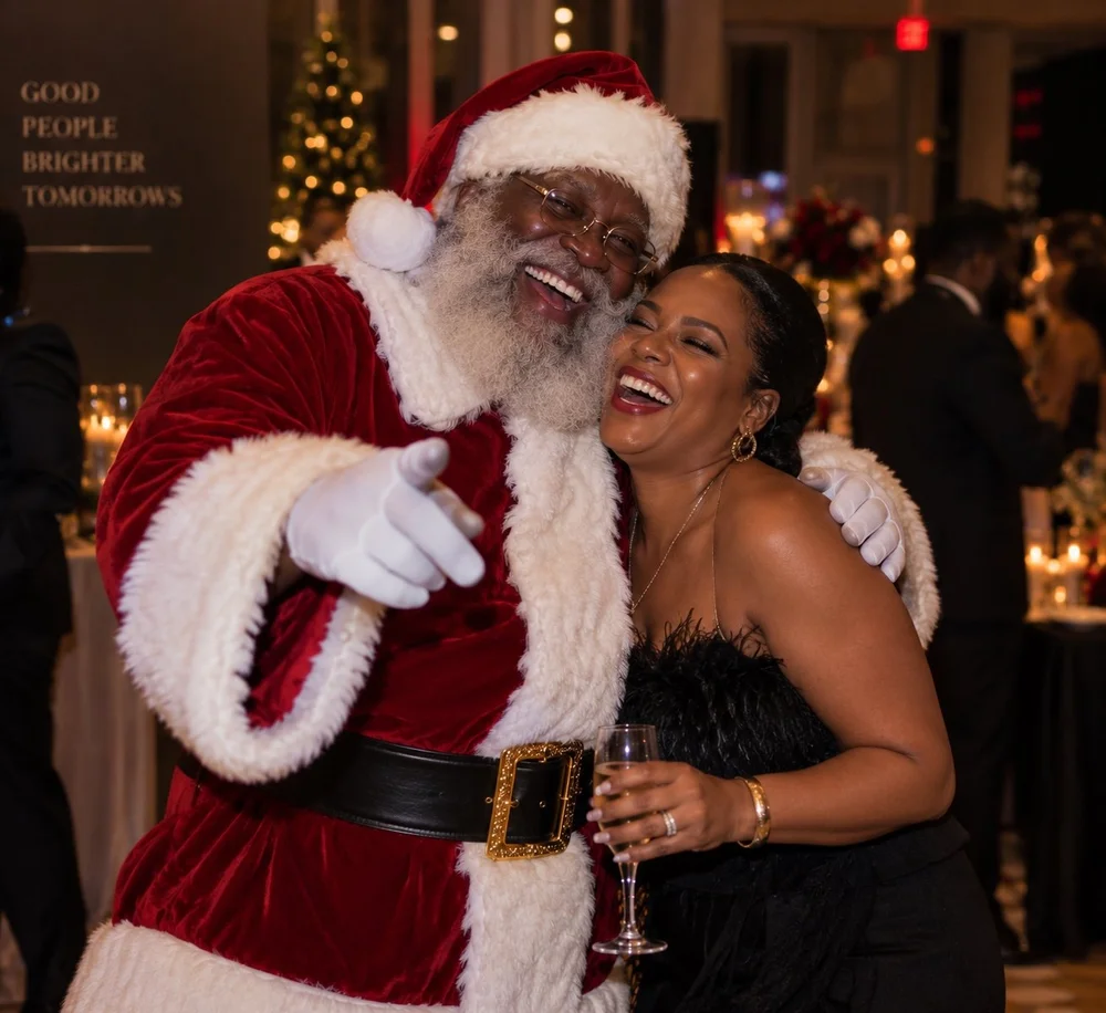Black Santa laughing with a guest at a holiday celebration