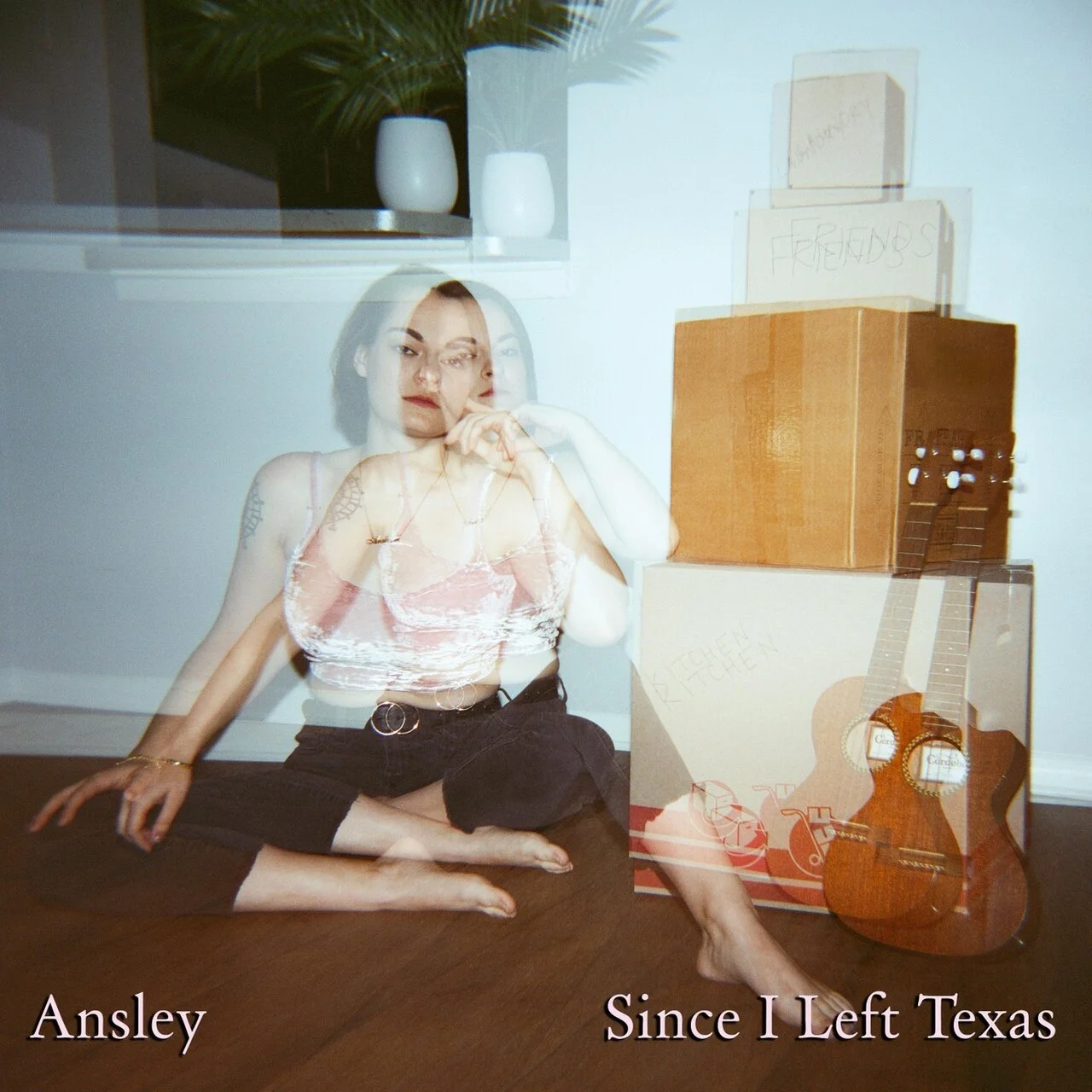 A woman sitting on the floor with boxes, a guitar, and notes in the background, with a ghostly double exposure effect showing her in two different positions. Text at the bottom reads, 'Ansley Since I Left Texas'.