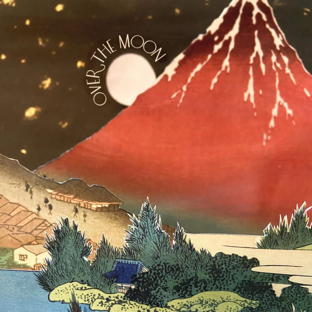 Illustration of Mount Fuji with snow on top, a full moon, and the words 'Over the Moon' in the sky, with trees, houses, and a body of water in the foreground.
