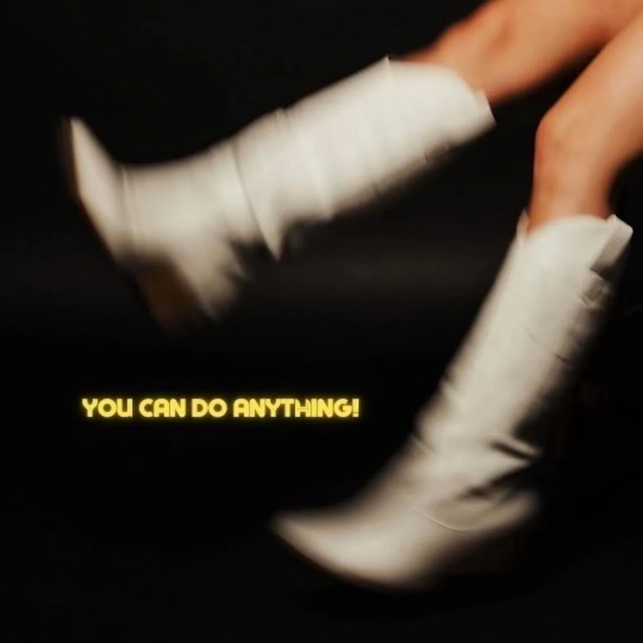 Hands with white sleeves reaching upward on a dark background with the yellow text "YOU CAN DO ANYTHING!"