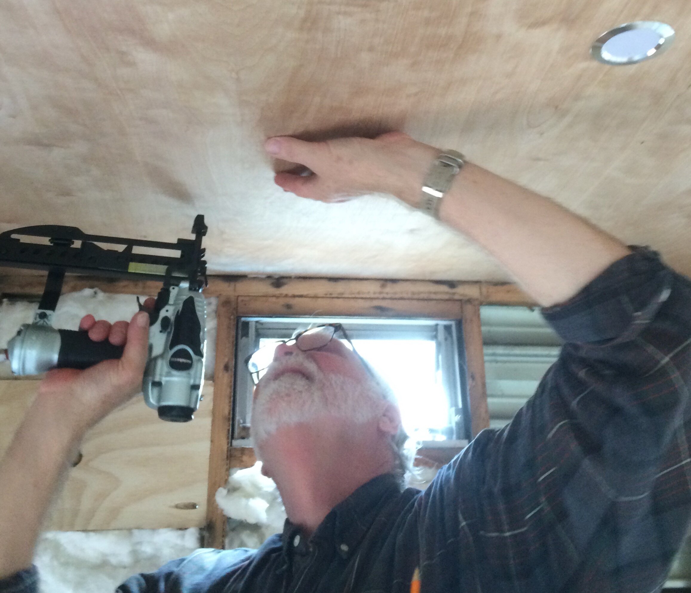 Vintage RV Renovator Extraordinaire Steve Shelburne installs Margie's birch veneer ceiling with recessed 12 volt lights.