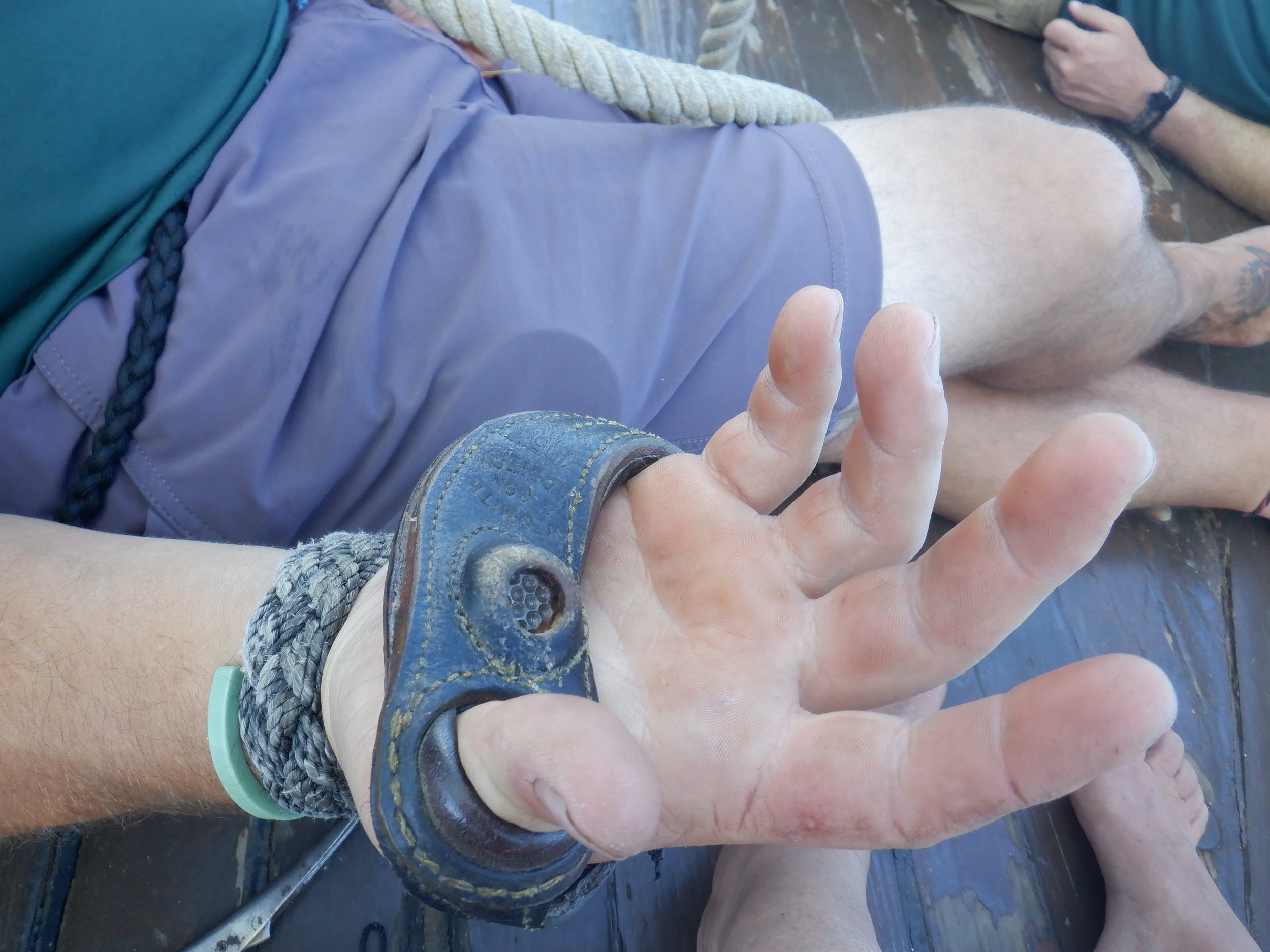 A leather sailmaker palm is worn for repairing sails and splicing lines.