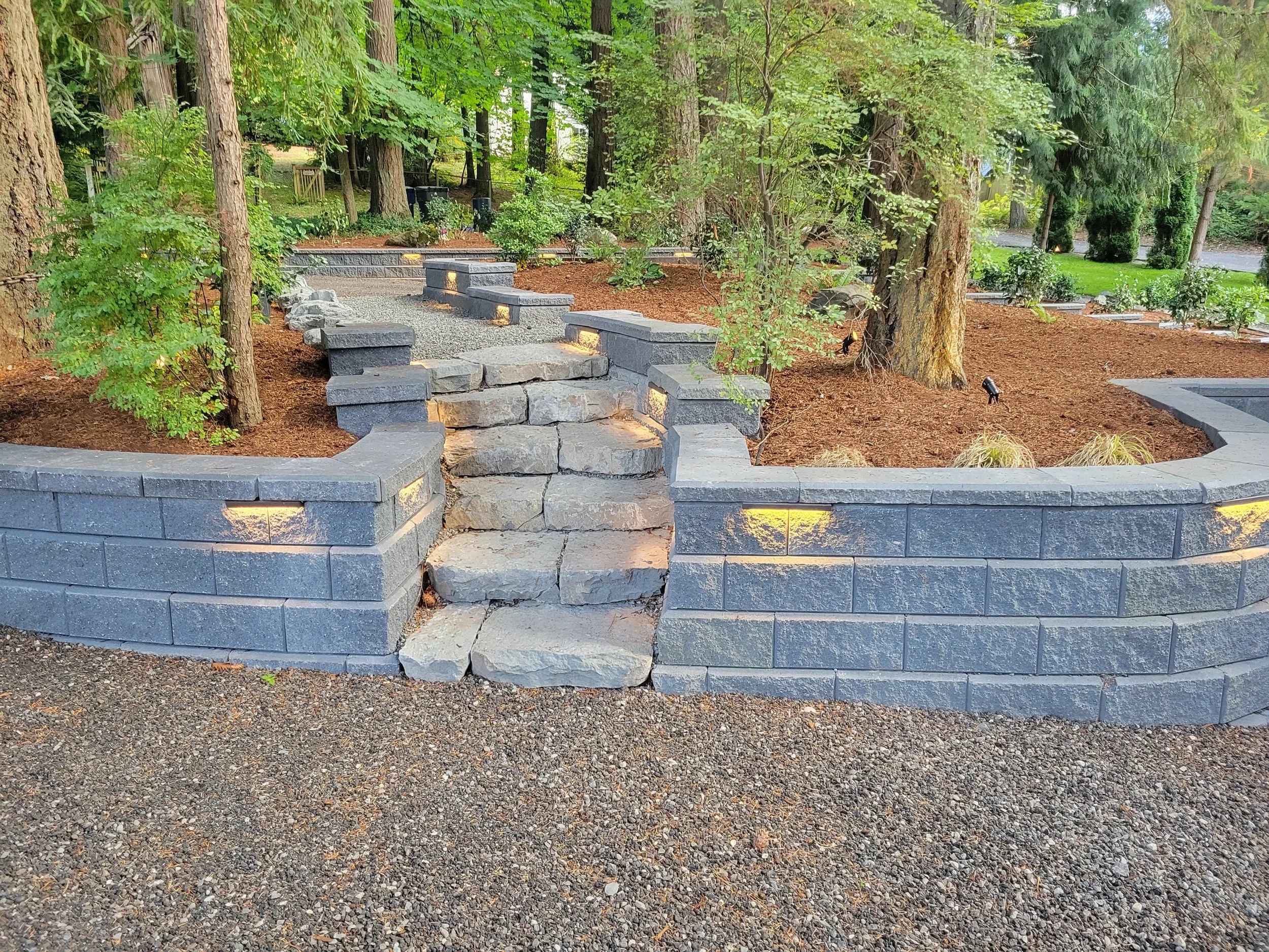 Custom hand-chiseled stone stairway and retaining wall in Woodinville featuring precision masonry, natural stone materials, and long-lasting construction craftsmanship.