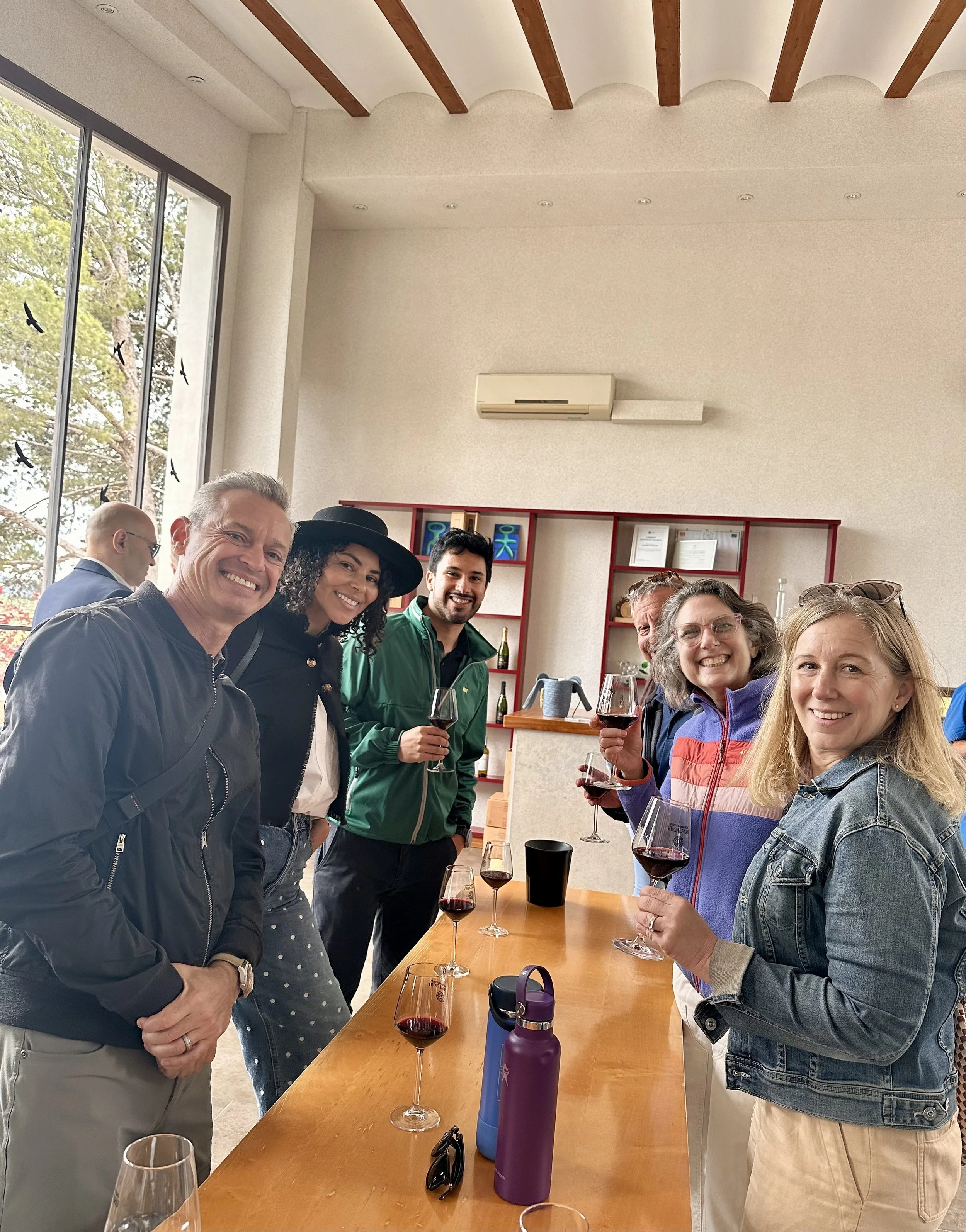 Encantada World clients wine tasting and sharing local dishes at an expat social event in Requena, Spain.