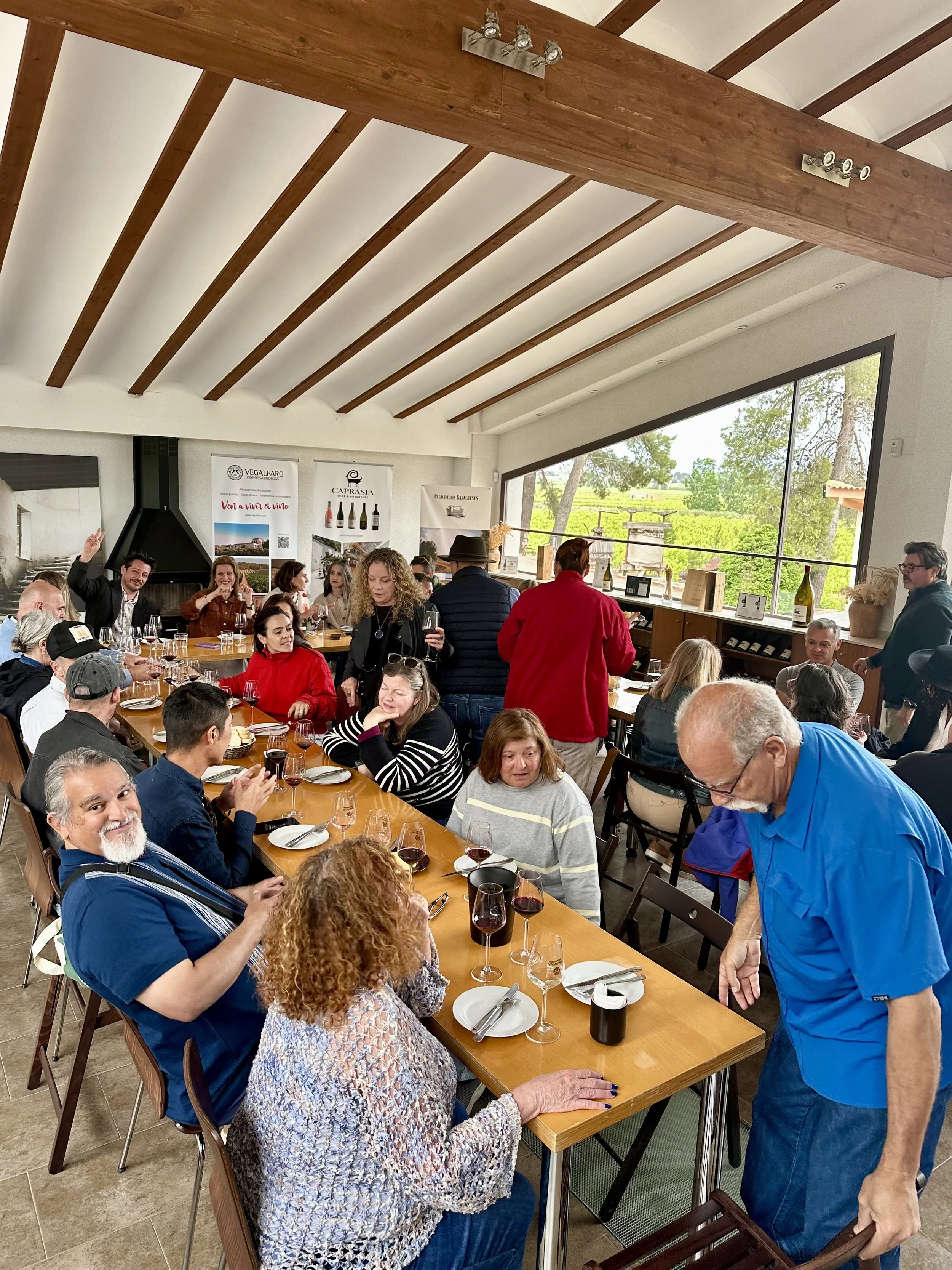 Encantada World clients wine tasting and sharing local dishes at an expat social event in Requena, Spain.