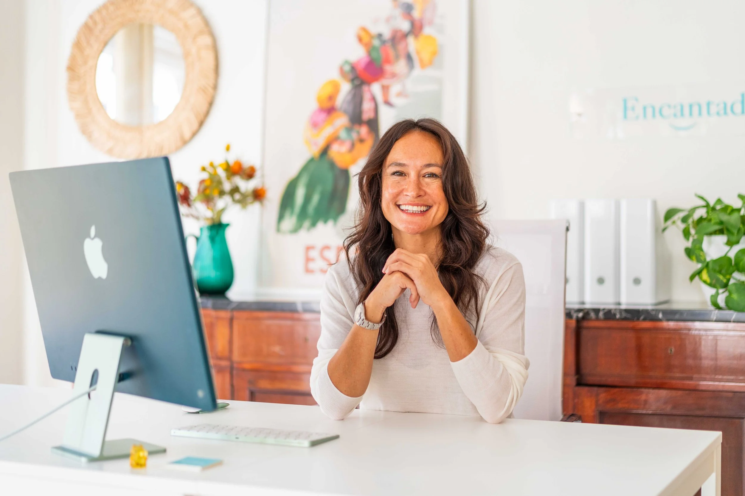 Stephanie Siu-Wai Kirtley, co-founder of Encantada World, smiling at her desk in the Valencia office
