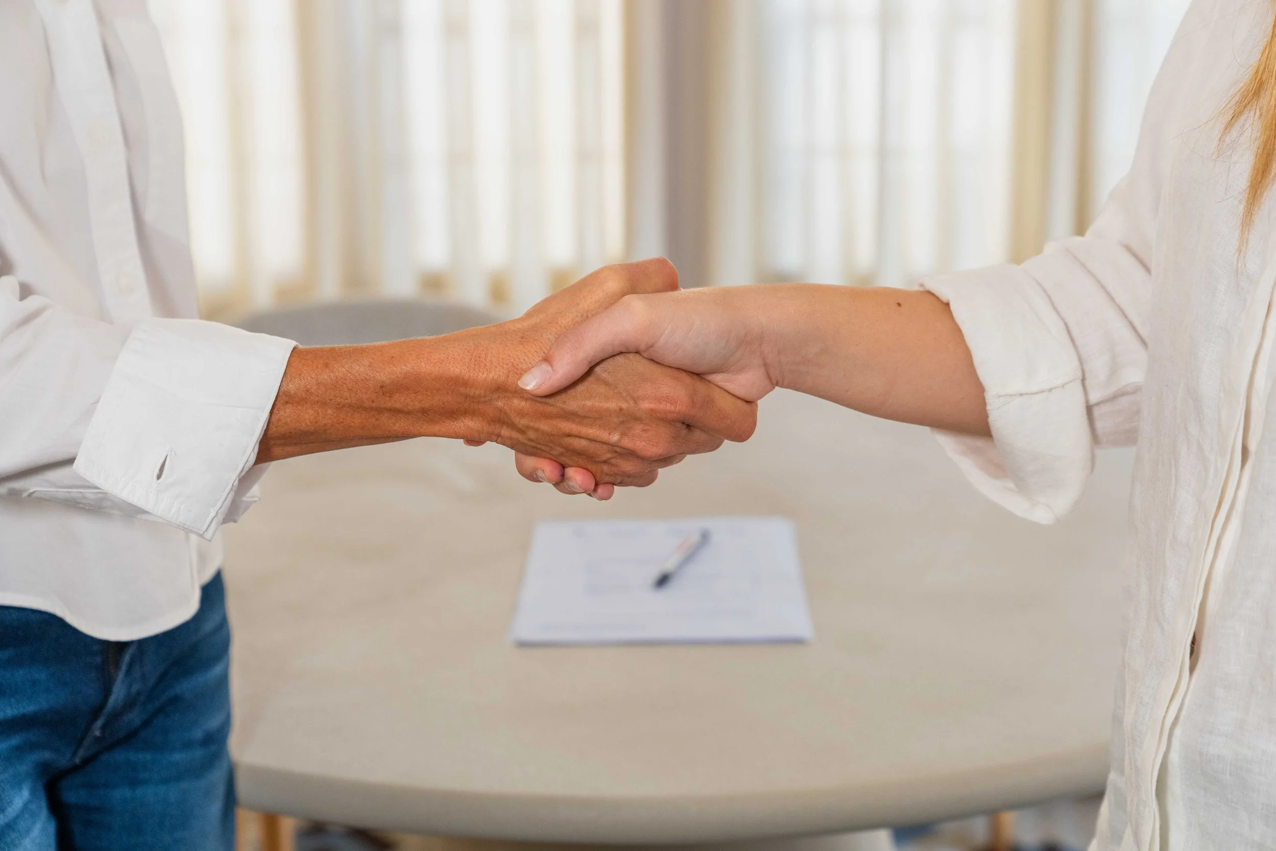 A handshake at the Encantada office which represents the promise we make on the services we deliver