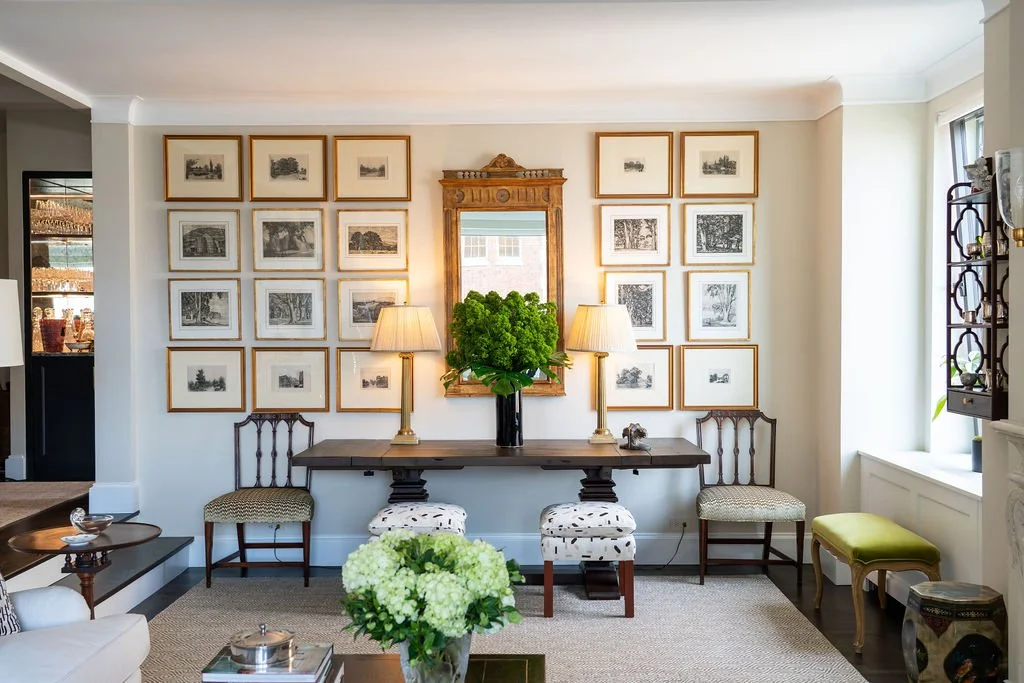 Living room console and salon-style art wall in a prewar Manhattan apartment designed by RI Architecture