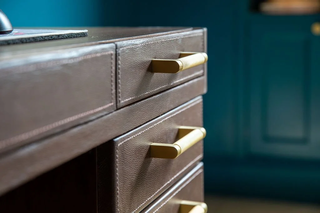 Custom leather wrapped desk with brass hardware by RIA, New York City