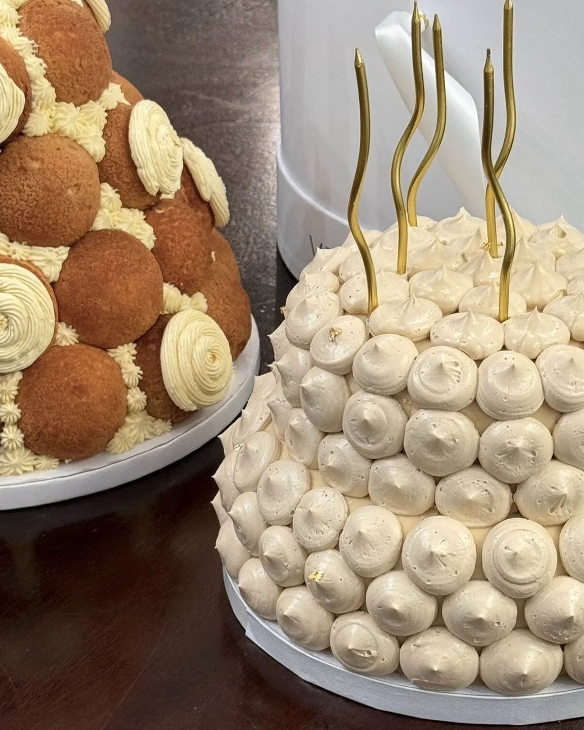 Our two tiered cloche cake and medium brown sugar choux cake with custom piping ✨