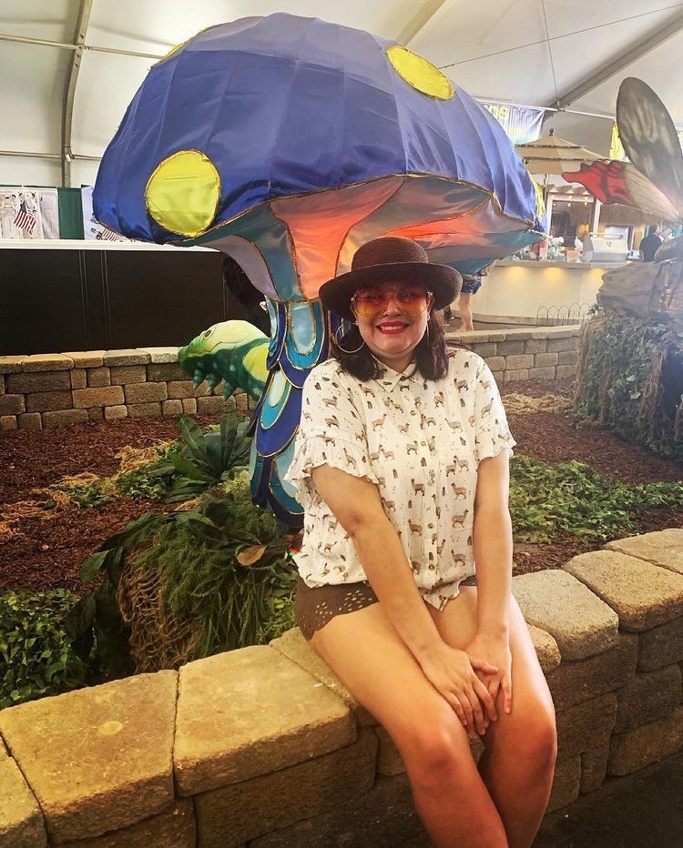 Woman wearing oversized yellow round V SHADES Sunglasses