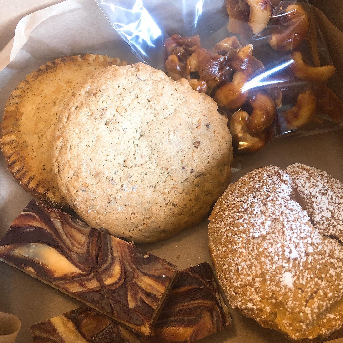 Here is our 2020+1 pastry box featuring our black eyed peas hand pie, cashew brittle with a hint of paprika, hazelnut cookie, sparkling grapefruit cream puff, and grand marnier marble cheesecake bars #delicious #detroit #supportsmallbusiness #pastry 