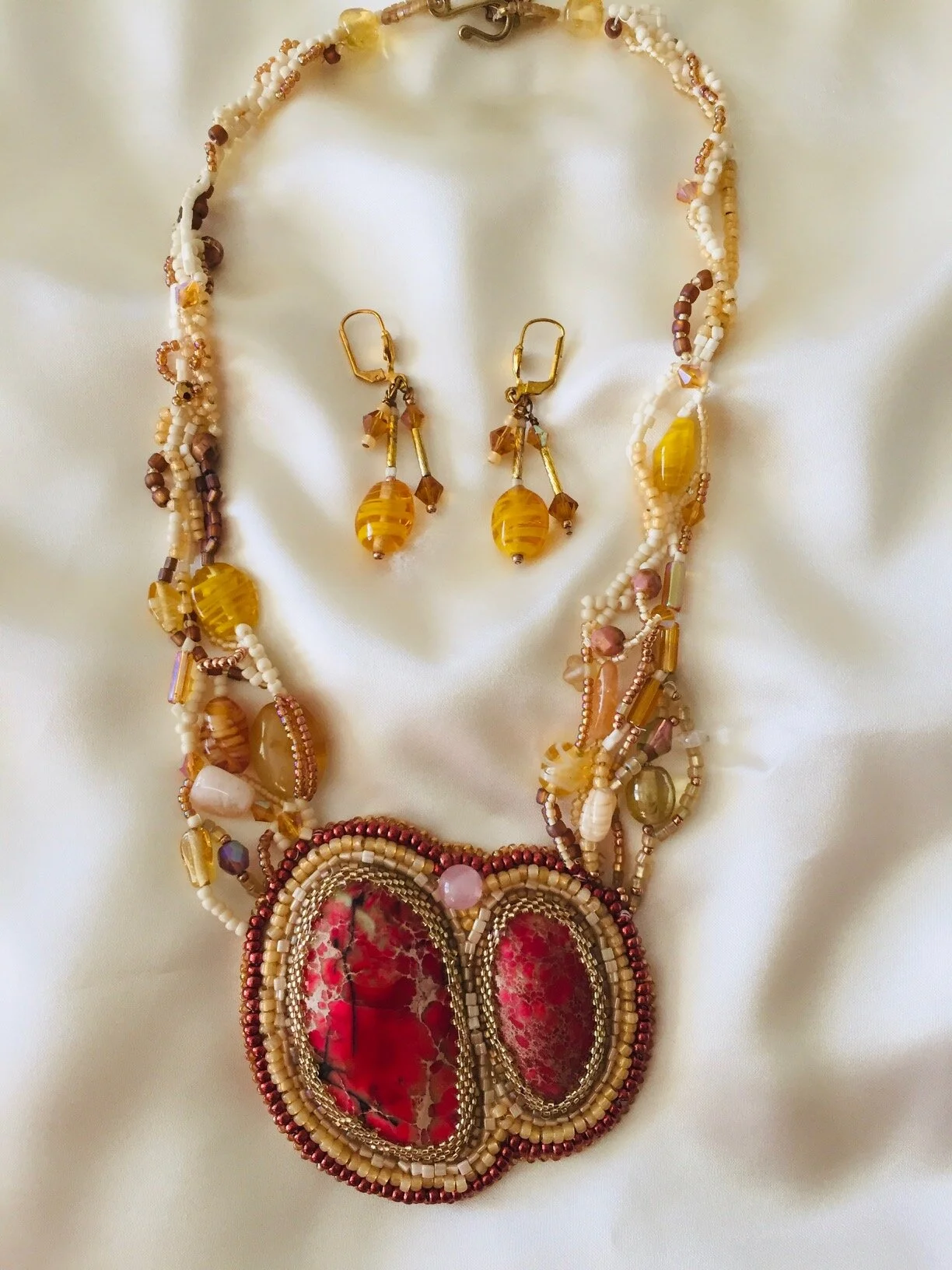N19 - Necklace with pendant and earrings. $300.00. Two orange agate cabachons, bead embroidered. , free form necklace beads 19”, adjustable, includes earrings.