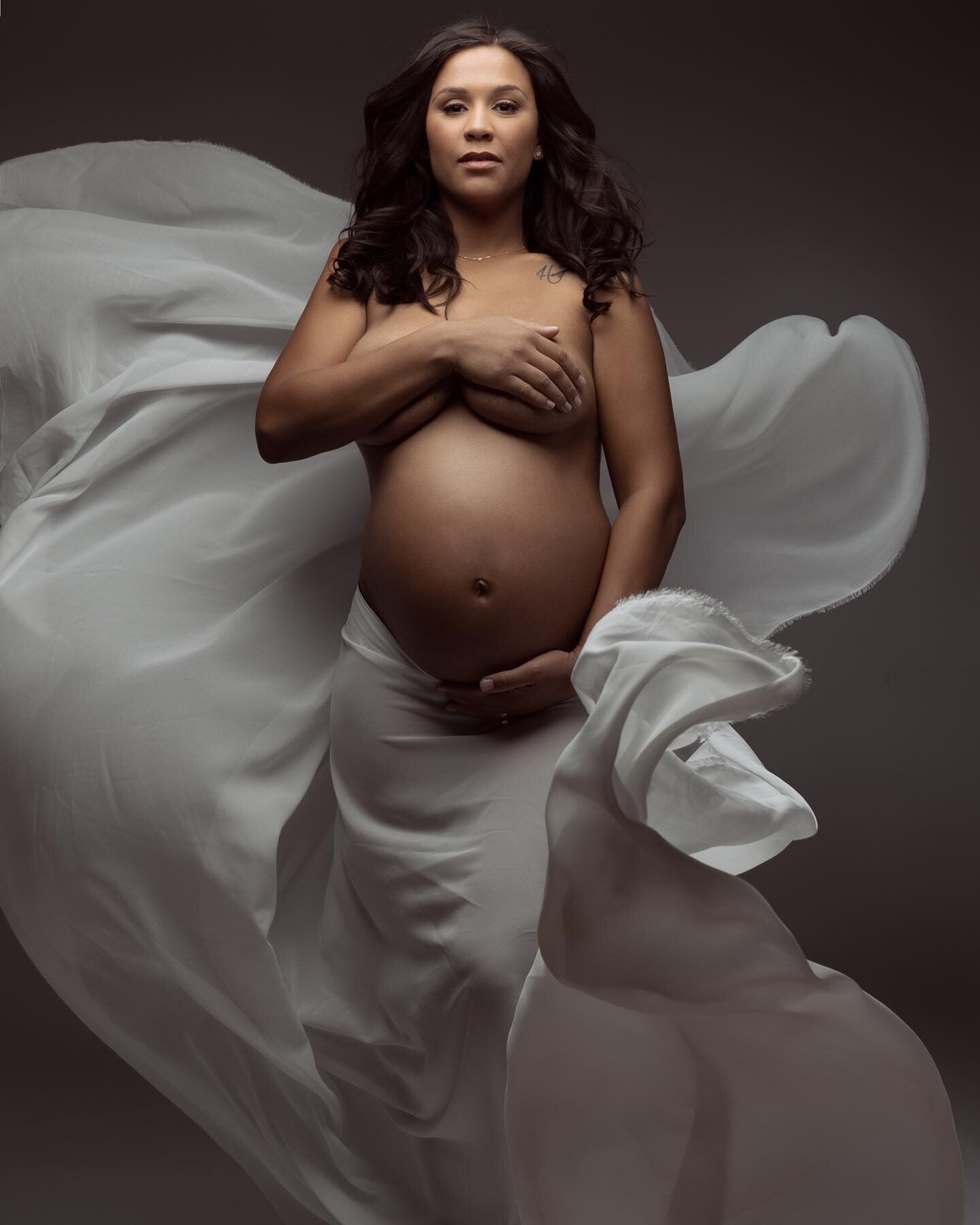 It's the classics that never go out of style especially when that style is executed flawlessly.  And this beautiful mother-to-be is rocking a classic, silk maternity dress that flows gracefully in the air as she confidently poses during her maternity