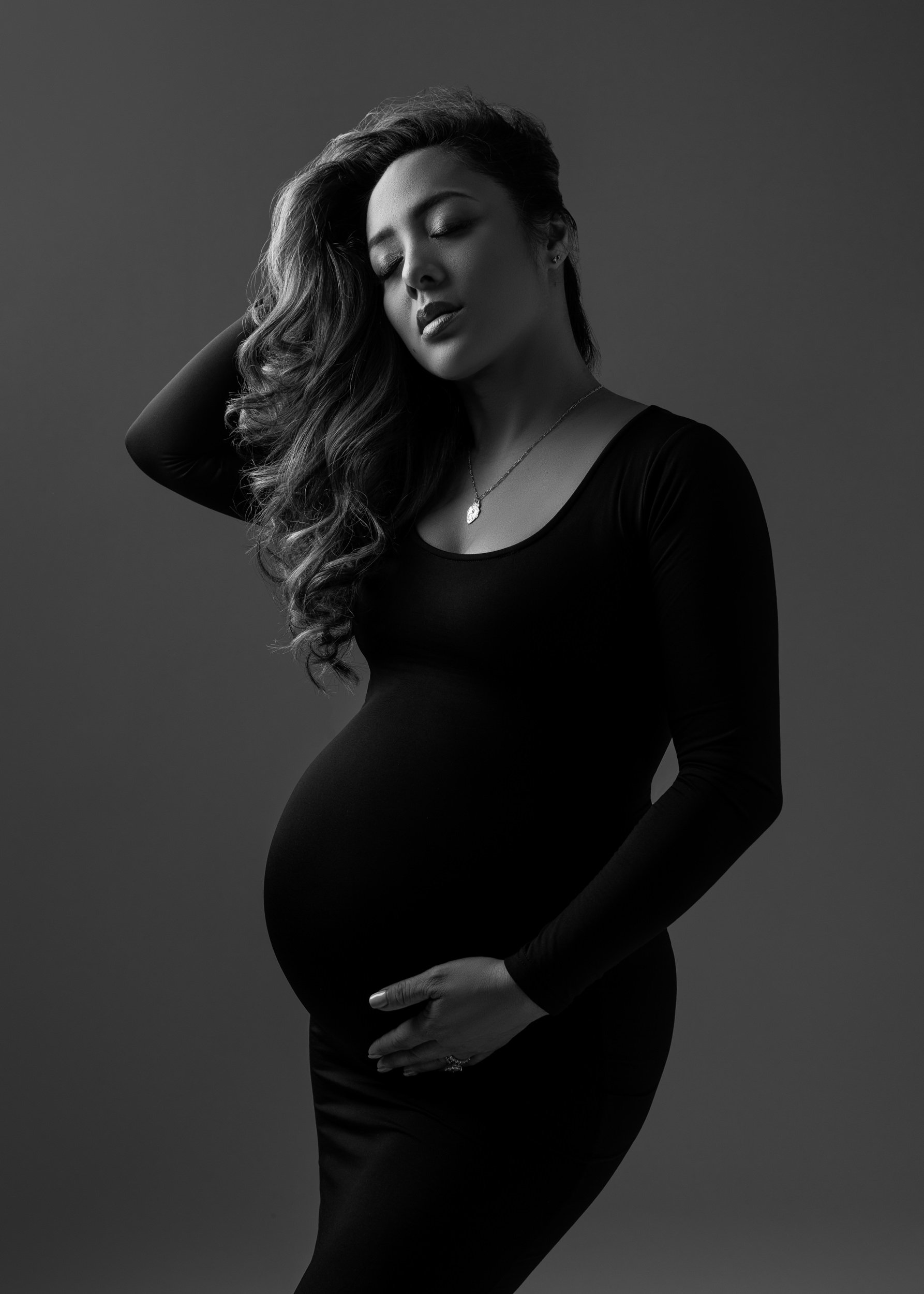 maternity-photoshoot-with-woman-in-bodycon-black-dress.jpg