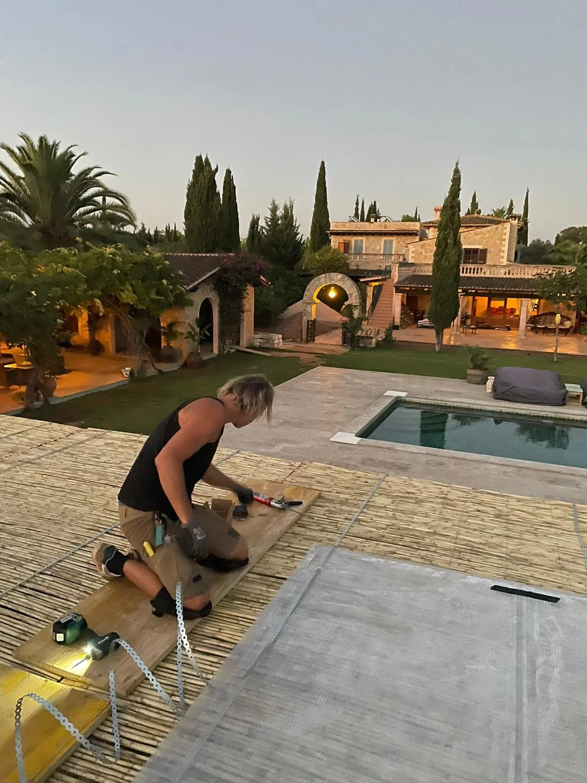 Hugo working on a custom pergola project at a Mallorca estate, showcasing hands-on construction experience with high-end residential properties.