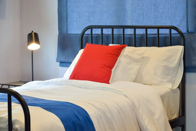 modern-bedroom-interior-with-pillows-blue-roman-blind_65102-395.jpg