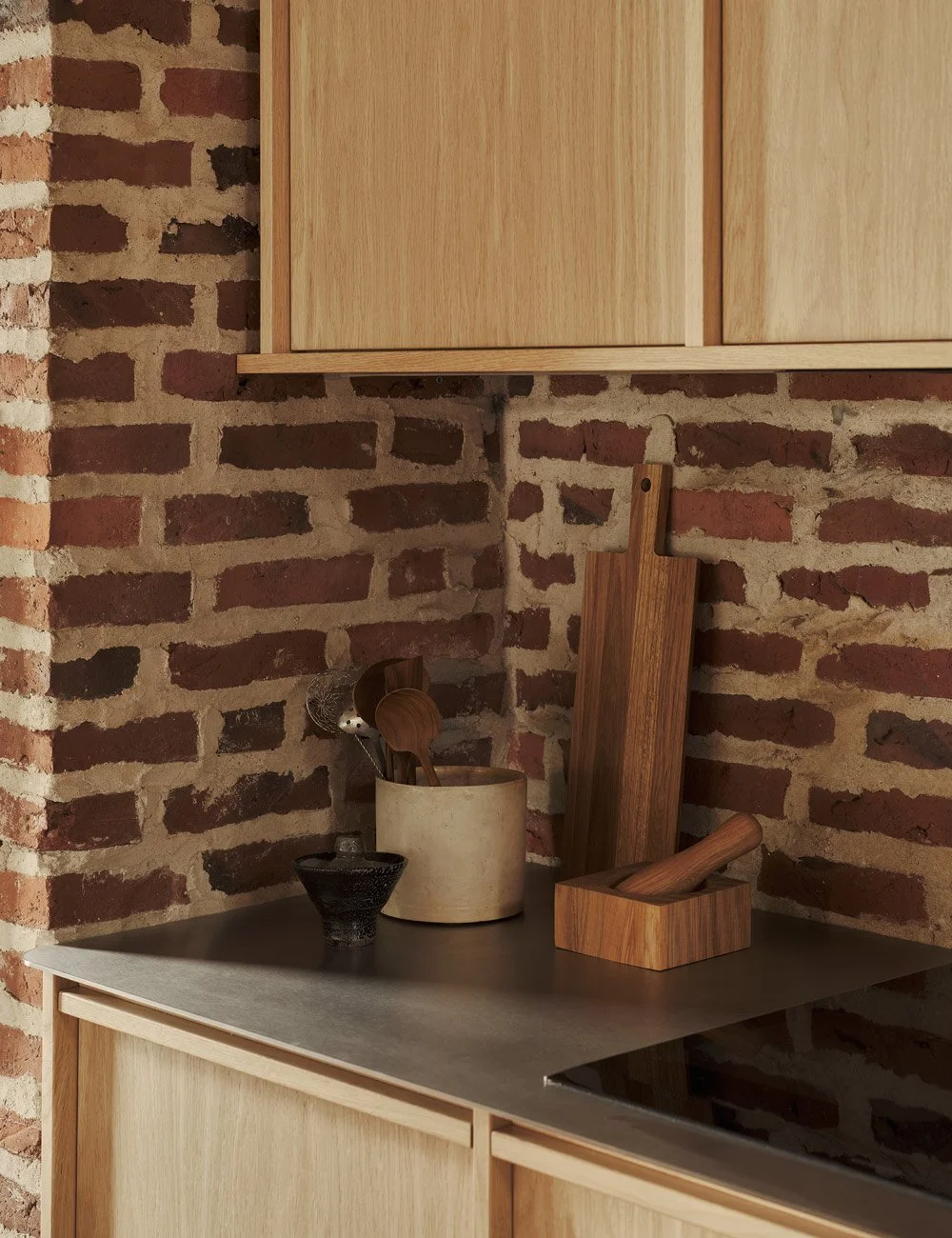 Light oak kitchen with stainless steel worktop.