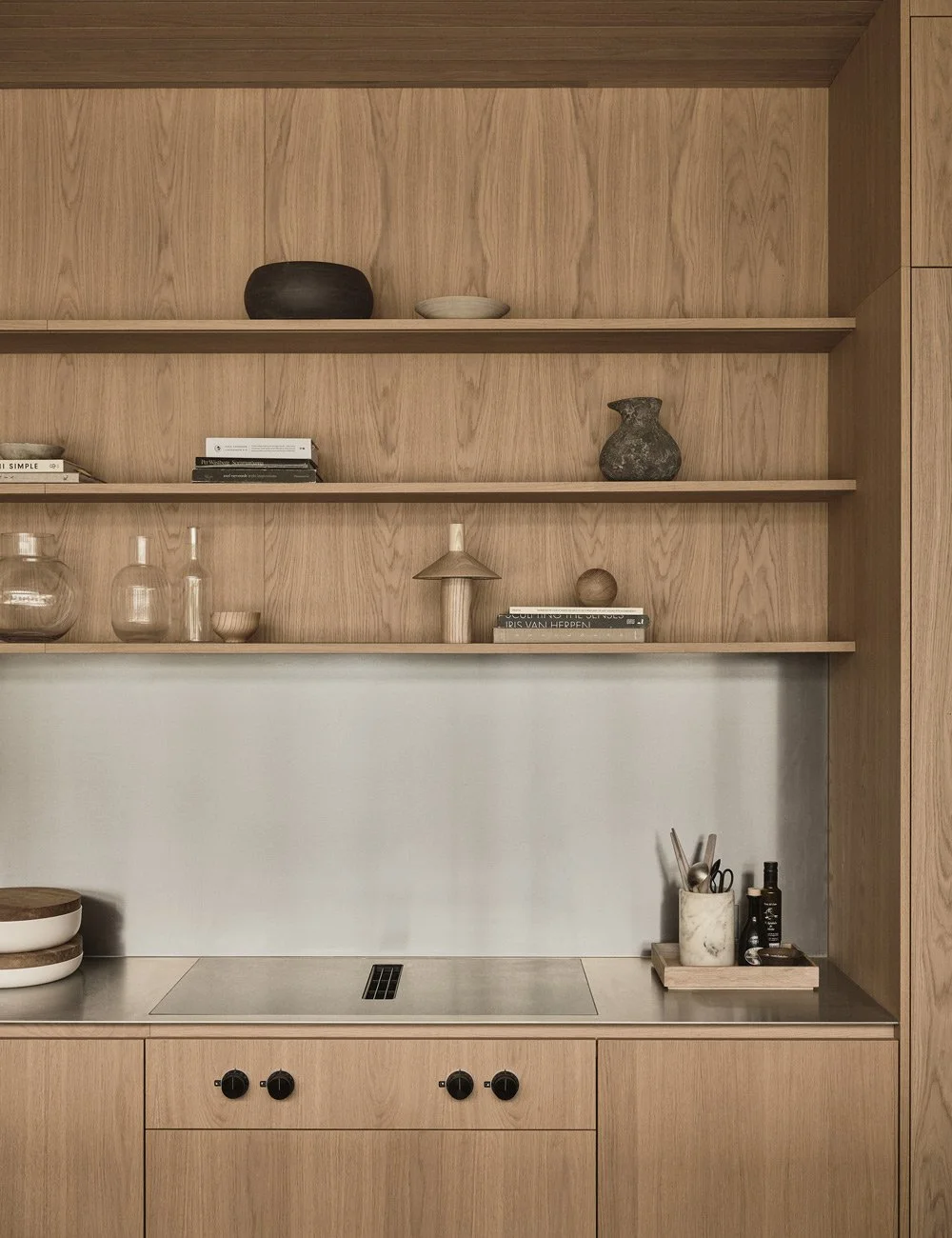 Bespoke light oak kitchen with stainless steel worktop and splashback.