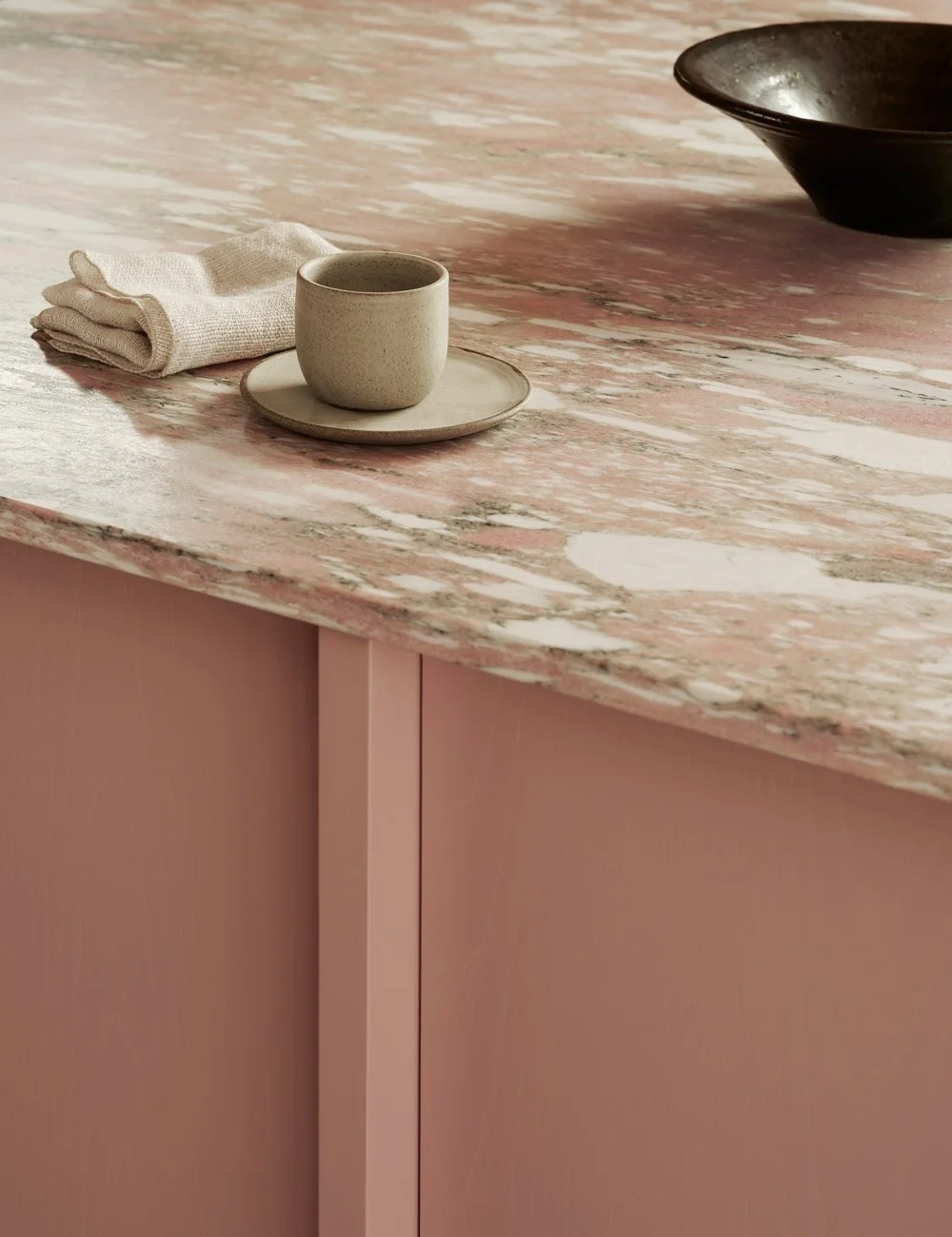 Pink kitchen island with matching Norwegian Fauske marble worktop in soft pink tones.