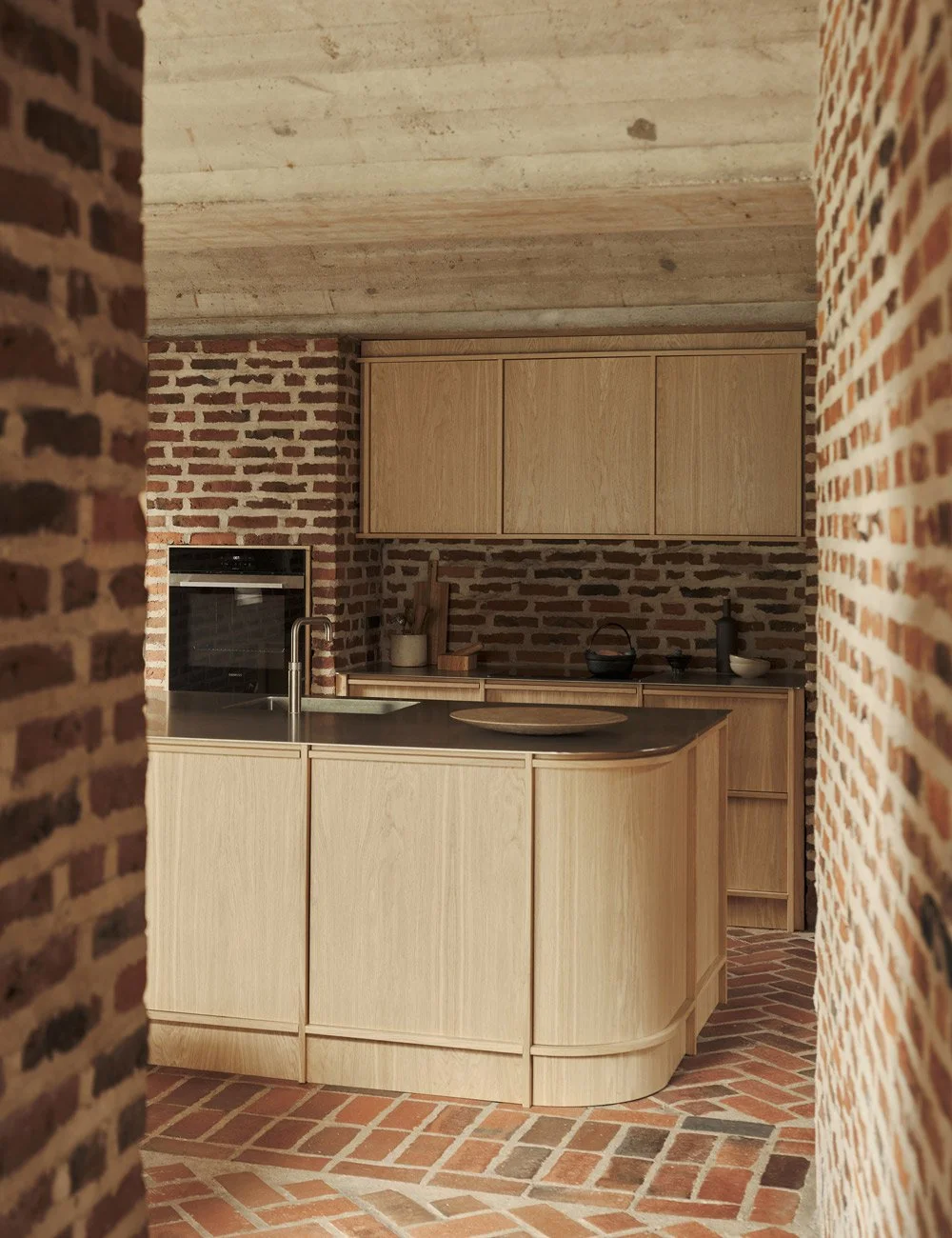 Light oak kitchen with stainless steel worktops in a Danish modernist house.
