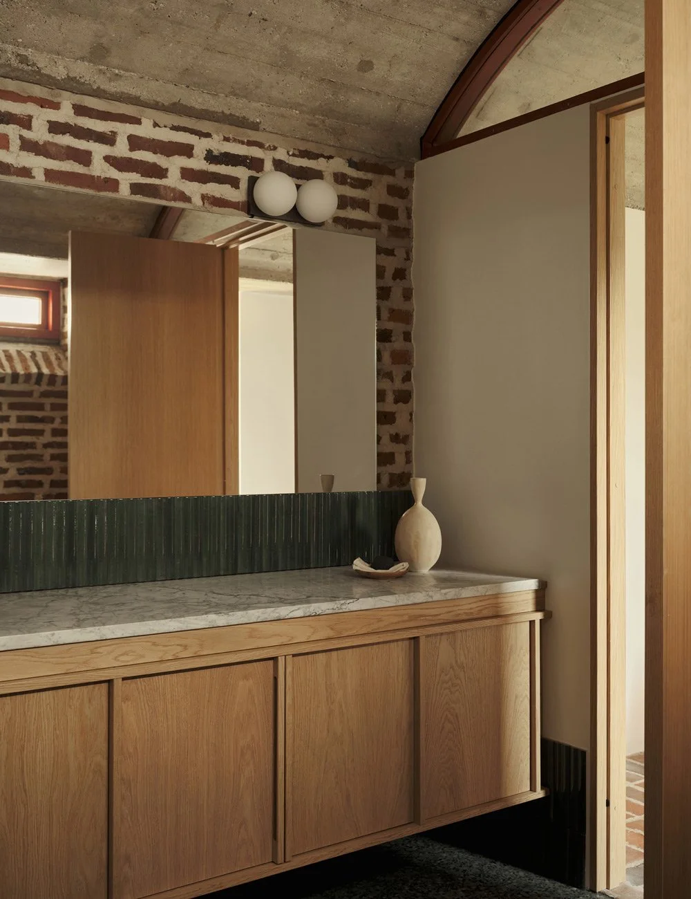 Bathroom with green tiles, terrazzo floor and bespoke light oak vanity in a 1970s modernist house.