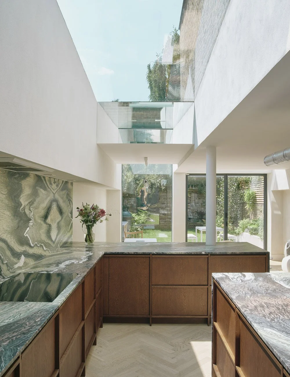 Bespoke Scandinavian kitchen in dark oak and green marble by Nordiska Kök in a Victorian London townhouse.