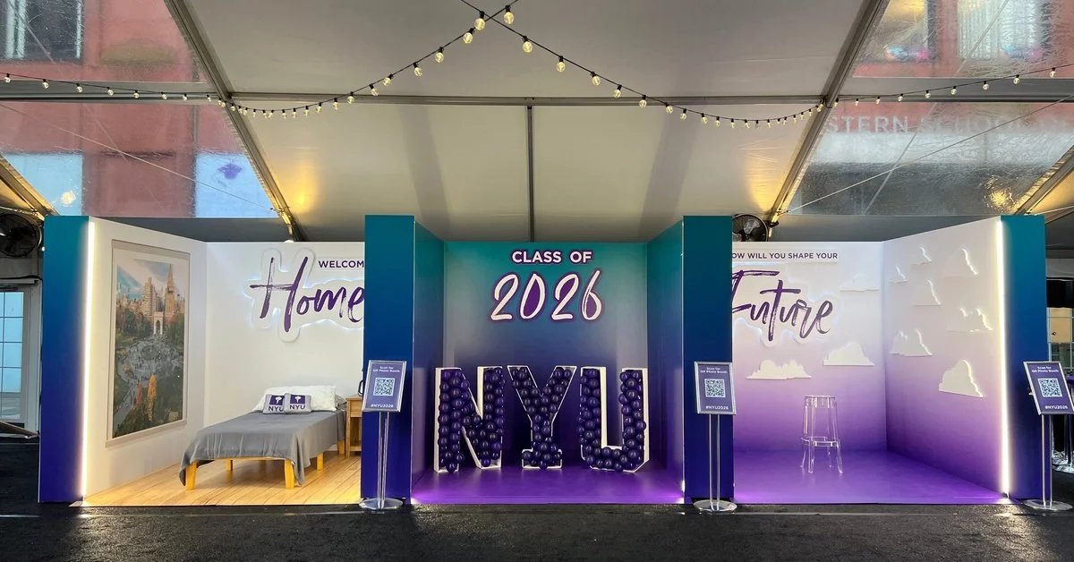 Three display areas set up for the NYU class of 2026. One area has a bed and another area has a single stool.