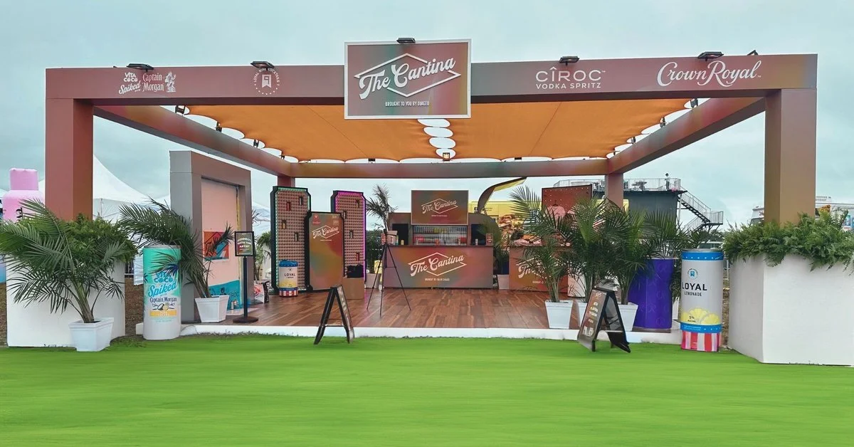 A large pop-up shop with multiple counters and shelves for showing off products. The sign above it says "The Cantina."