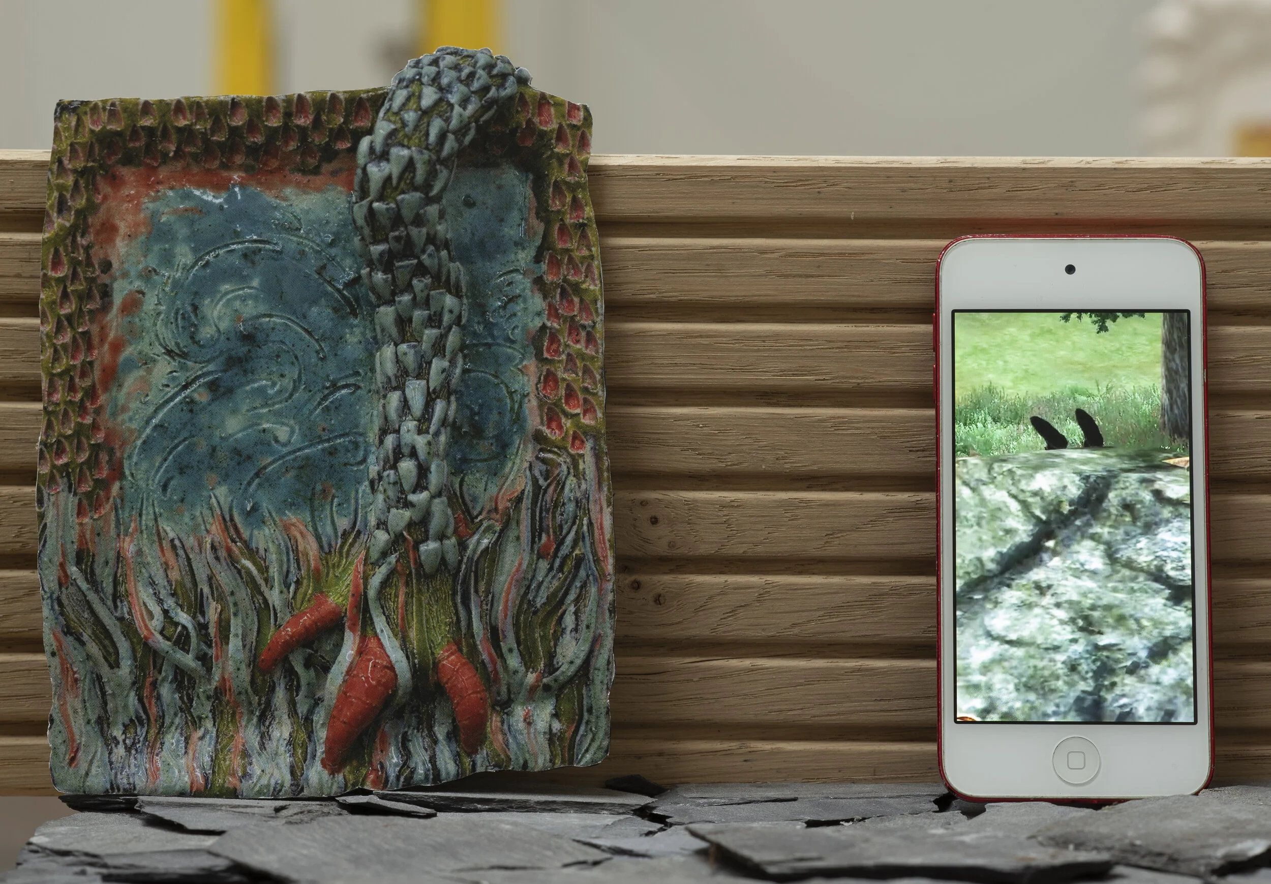 Mitre & Monday’s model, detail shot of: Left to right: Sophie Goodchild Come lay down your aching limb (2019), ceramic, original size 30 x 21cm & Worrier Will (Will Stockwell + Christian Wright) Collaborative demise (2020), portrait video, [9:16]

Ph