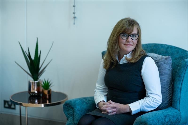 Karen Photo sitting on Blue chair.jpg