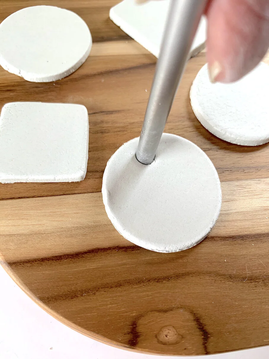 punching a hole for ribbon in clay gift tags