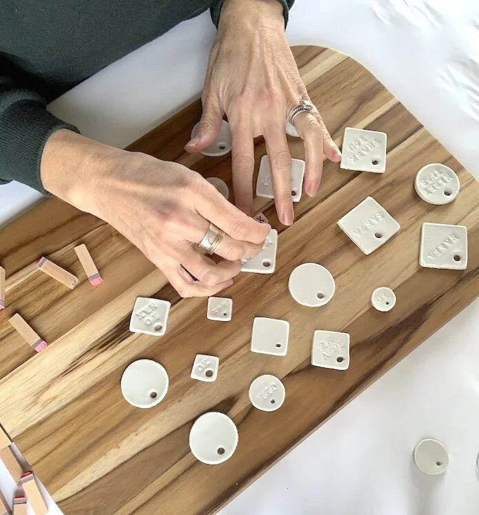 stamping letters into custom clay gift tags