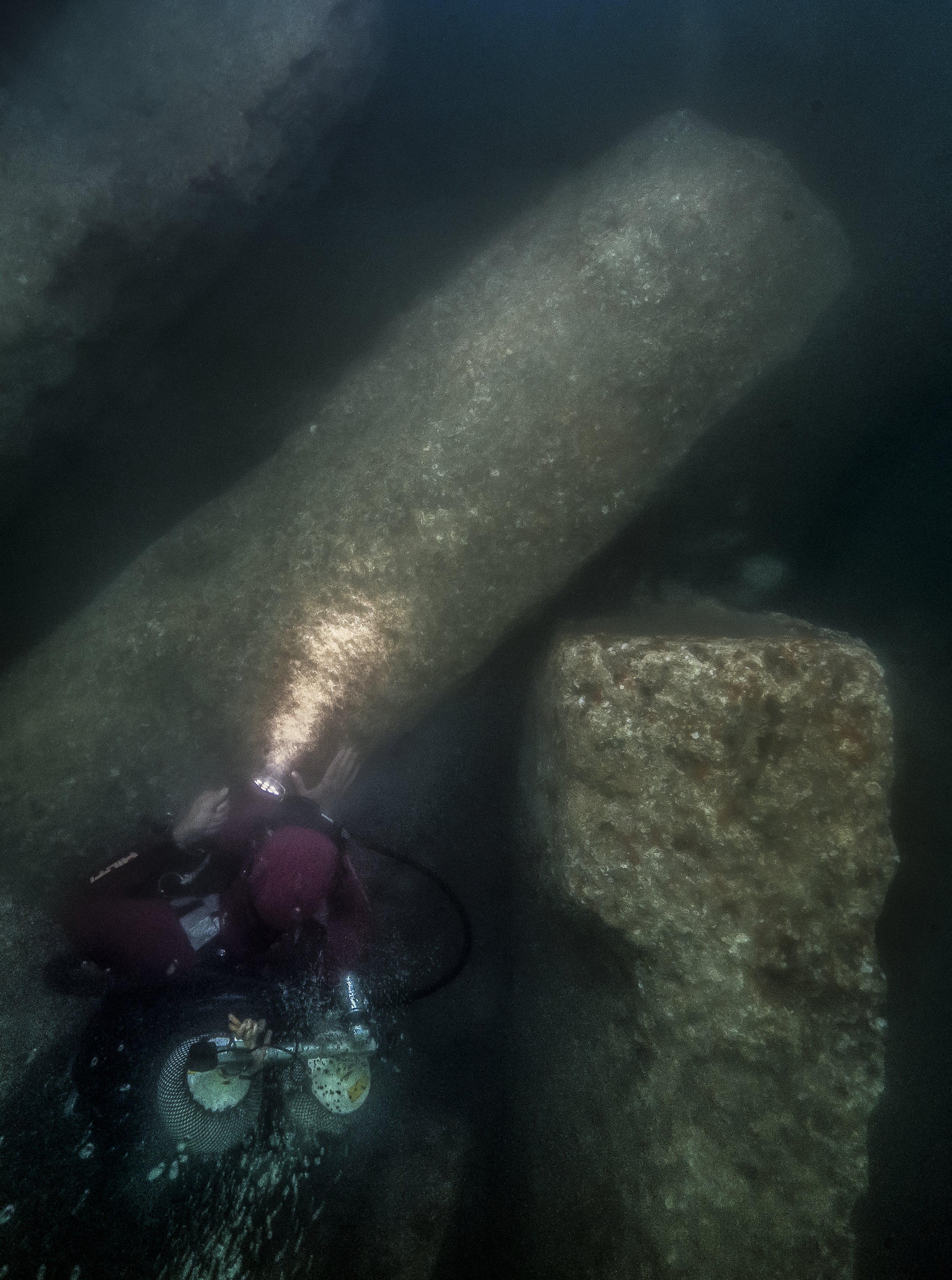  After excavation, an archaeological diver gazes at the huge blocks of the Amun temple, which fell in the mid-second century BC in the South canal of Thonis-Heracleion. They were discovered under 3 m of hard clay.&nbsp;  ©Franck Goddio/Hilti Foundati