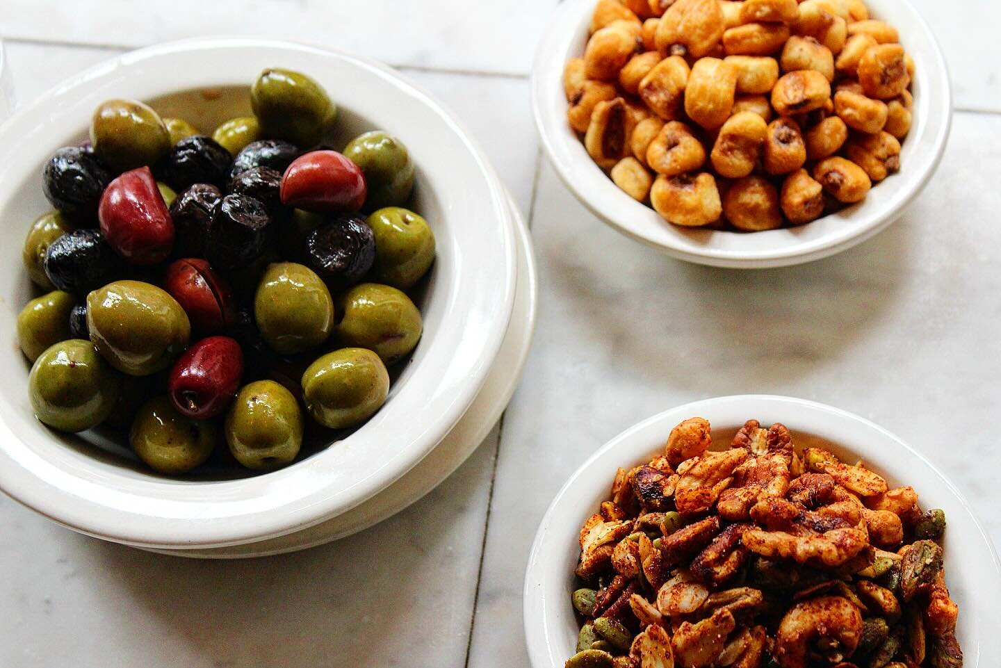 Craving a salty snack while imbibing? Well both bars now have snacks! 
Choose from salty corn nuts, mixed olives, or housemade voodoo spiced nuts (inspired by @realzappschips voodoo flavor!)