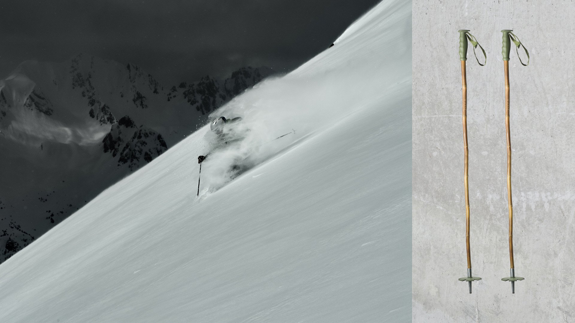 Skier in deep powder with moody mountain backdrop.