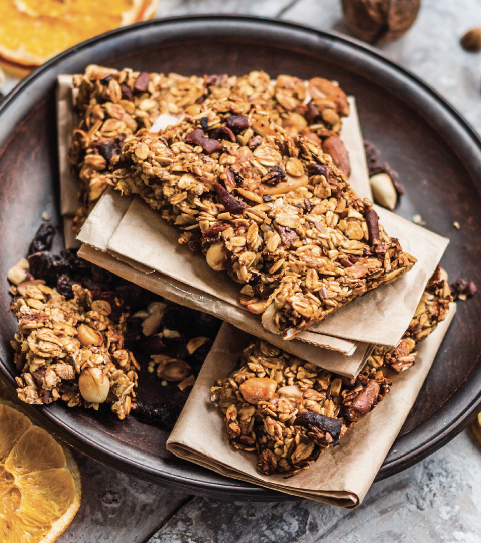 Orange-flavored granola bar with visible oats and citrus glaze representing bright, natural flavor ingredients.