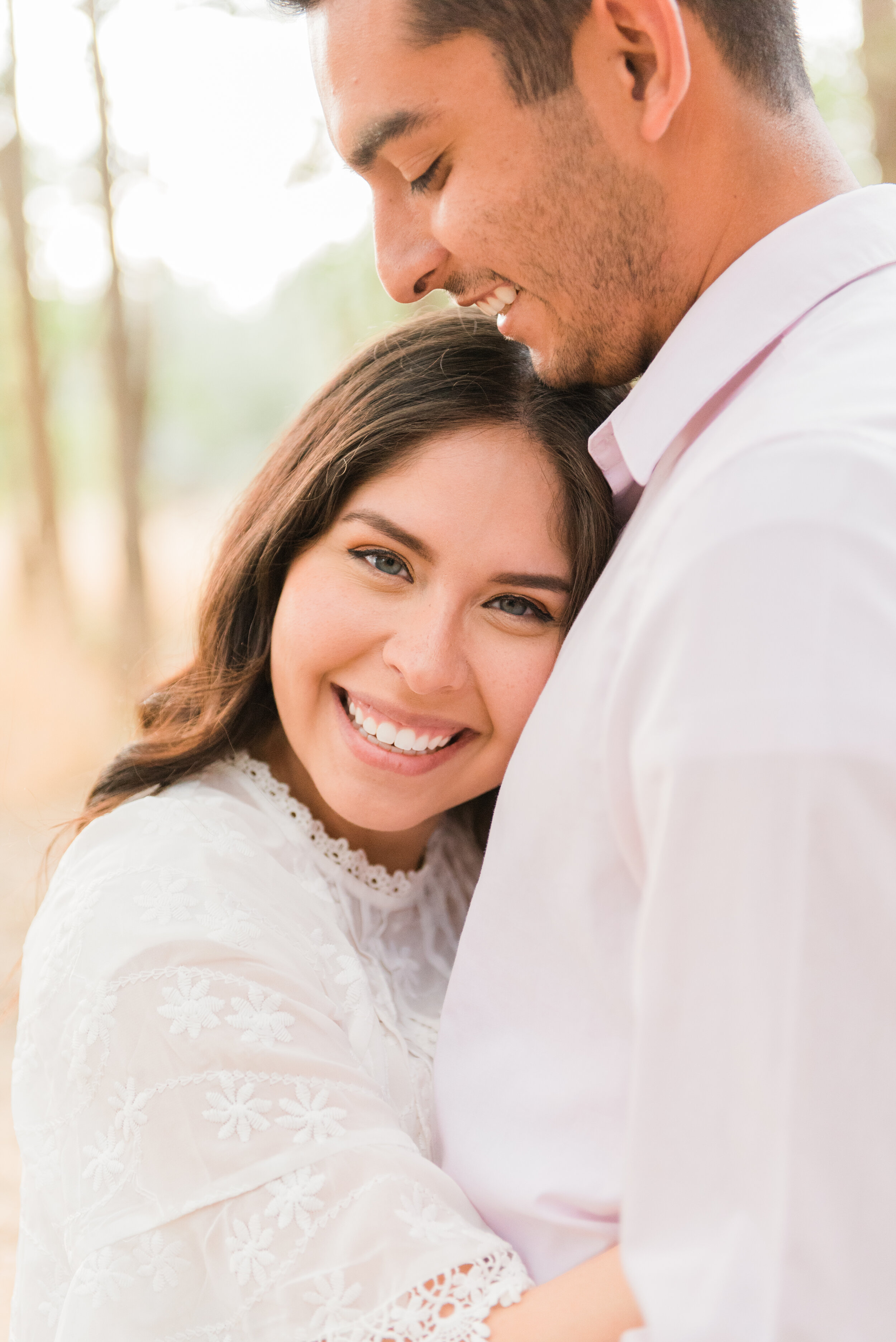 A beautiful smile captured in Maryland at an engagement photoshoot with Jacquie Erickson Photography. Smile pose picture inspiration white lace dress white button-up outfit coordination wedding look engagement pics styled shoot blue eyes curly hair