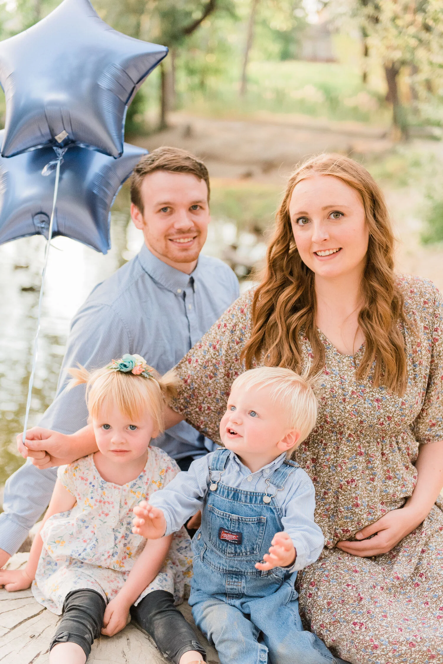  During their family photo shoot in Baltimore, Maryland with Jacquie Erickson Photography captures this mother holding two blue star-shaped balloons to announce the arrival of twin boys! twin boy pregnancy announcement, baby announcement with balloon