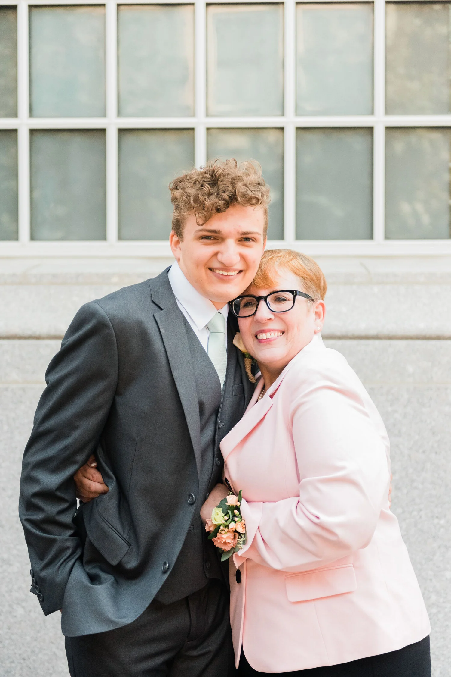  A groom and his mother are all smiles outside the Philadelphia LDS temple. Groom outfit inspiration sage green tie for weddings philadelphia LDS temple washington dc photographer pennsylvania photography outdoor wedding photogtaphy bright wedding ph