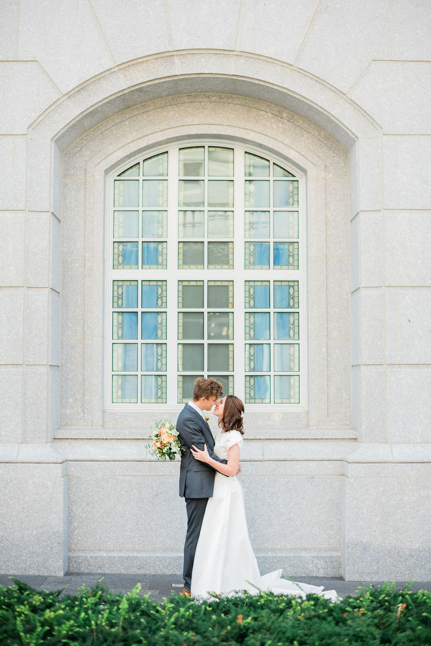  A bride and groom are perfectly framed by a window at the Philadelphia LDS temple. Outdoor photography lds wedding in pennsylvania picture ideas for your wedding day must have photos on your wedding day bright wedding photography maryland wedding ph