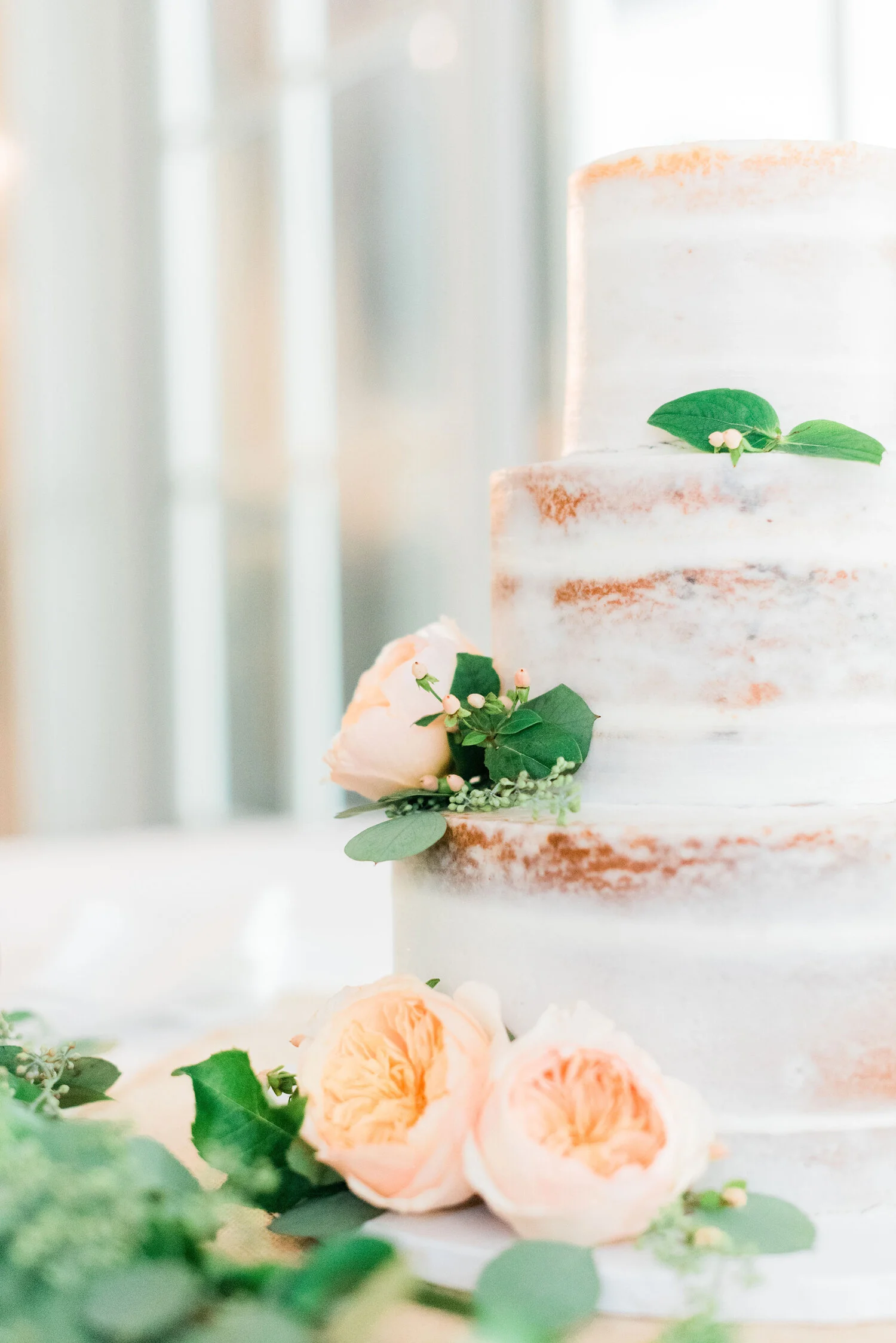  Close-up of a beautiful simple wedding cake decorated with blush peonies and eucalyptus. Wedding cake ideas white wedding cake how to style a simple wedding cake blush wedding ideas maryland wedding photography wedding details philadelphia wedding c