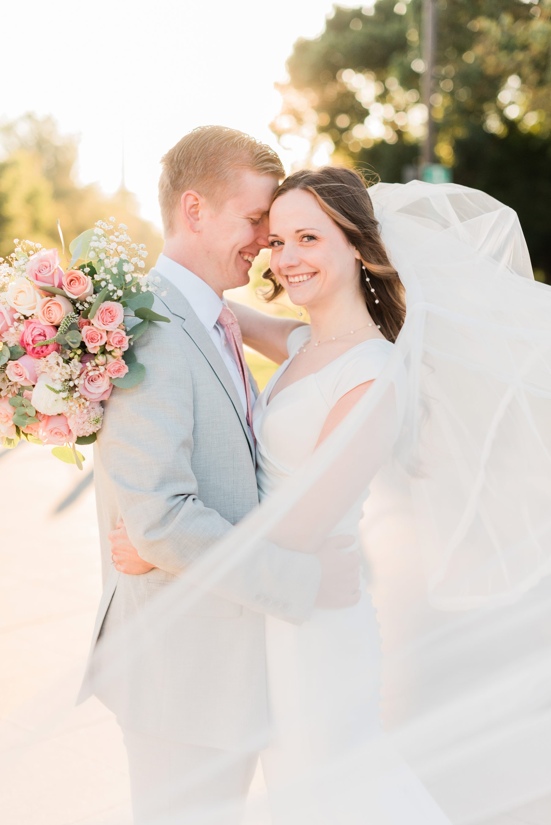  Jacquie Erickson photography captures a young couple during a bridal photo session. Bride looks happily at the camera while leaning her forehead on her groom. #bridalphotosession #portraitphotography #atlantaphotographer #jacquieerickson #fayettevil