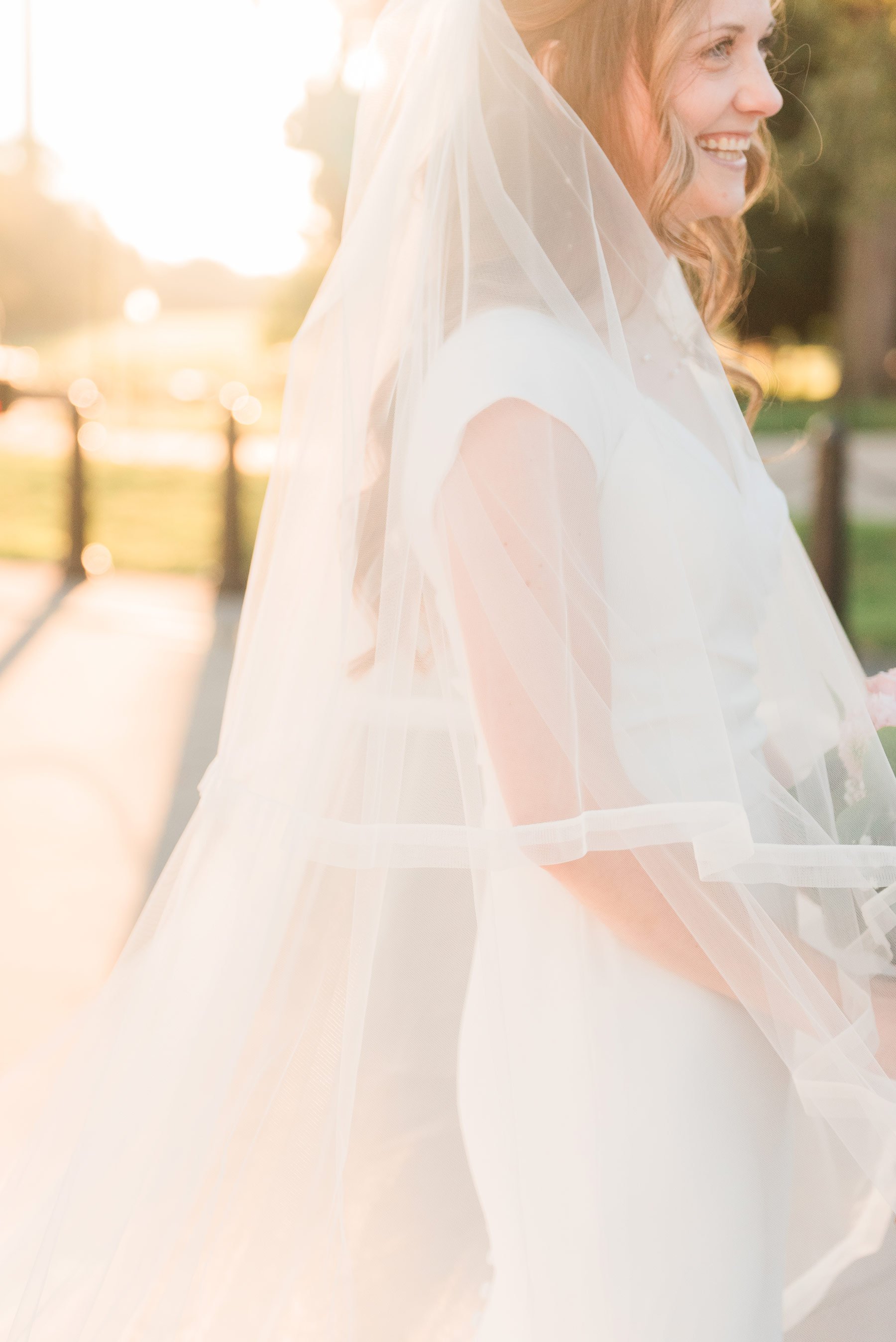   A gorgeous golden hour photo of a happy Washington DC bride at the temple grounds. #washingtondcphotography #washingtondctemple #washingtondcwedding #dcweddingphotographer #washingtondctemplewedding #eastcoastweddingphotographer #sunsetbridals #mo